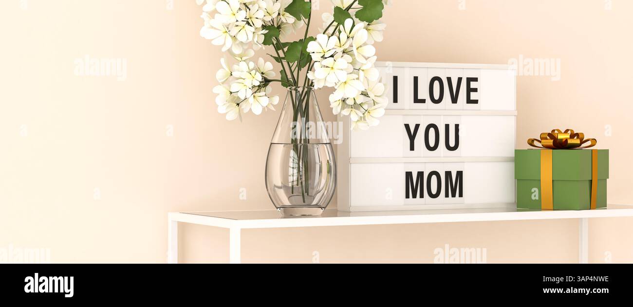 Une visionneuse affichant les mots « je t'aime maman » sur une étagère avec un bouquet de fleurs en géranium dans un vase en verre et une boîte cadeau verte avec une côte dorée Banque D'Images