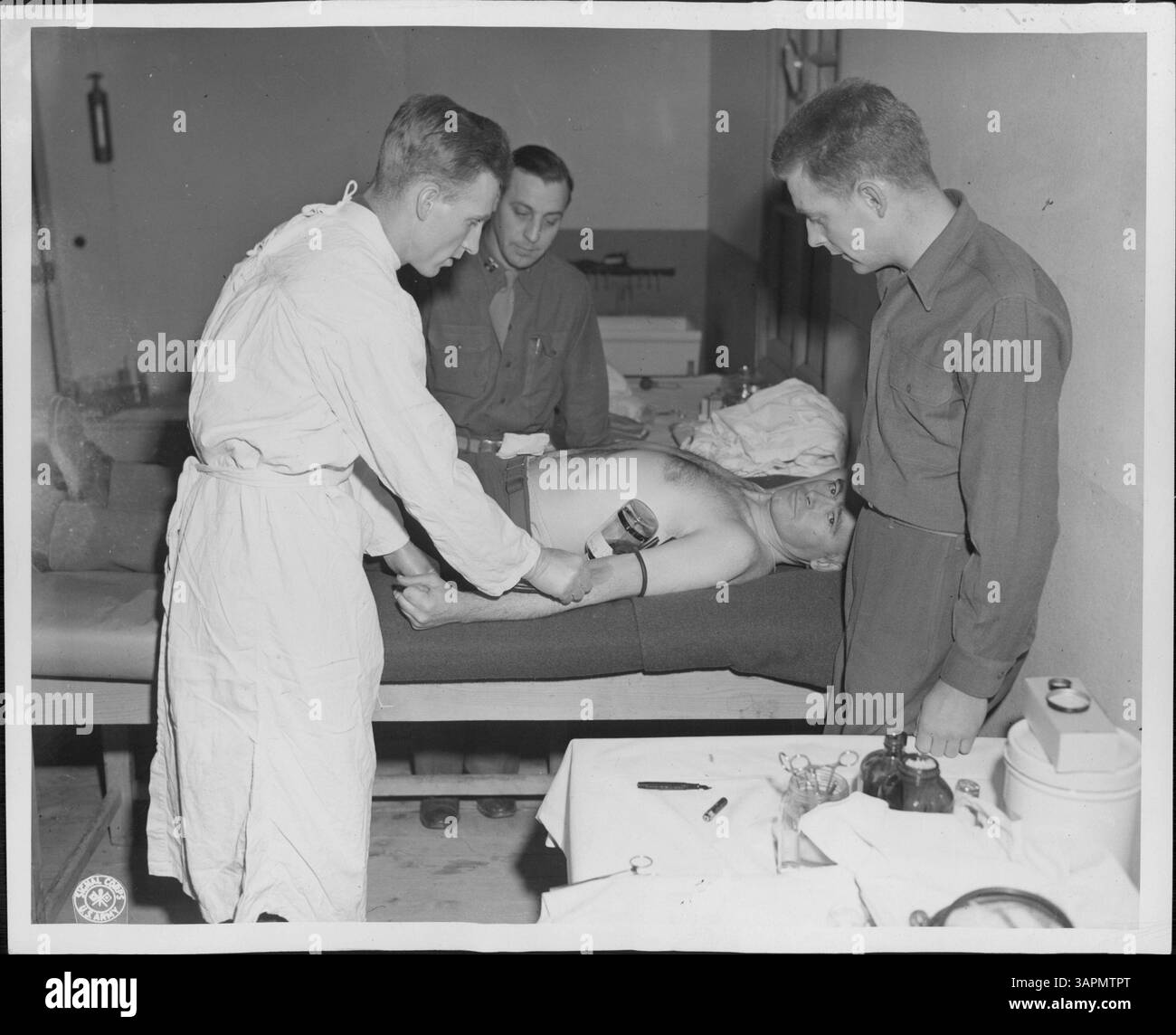 Cette image montre T/3 Muthern de Rosindale, Massachusetts, en tant que 500e volontaire à donner du sang au 36e Hôpital général. Photo avec le capitaine Nelson de Minneapolis et le caporal Krachmalski d'Uniontown, Pennsylvanie. Banque D'Images