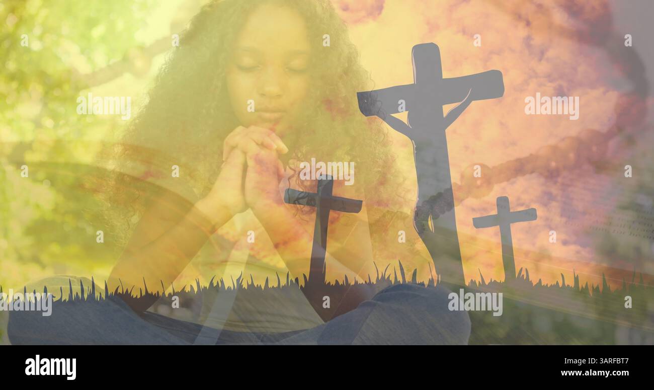 Image de croix sur une fille afro-américaine priant Banque D'Images