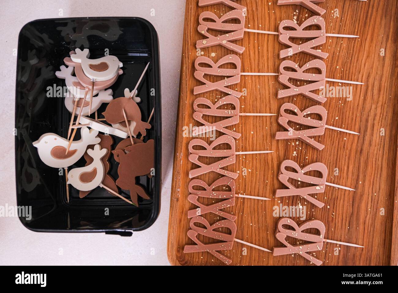 Moscou, Russie, 18.04.25. Un plateau de brownies avec des lettres dessus est sur une table en bois. Les lettres épellent le mot « bébé » et sont entourées de sm Banque D'Images