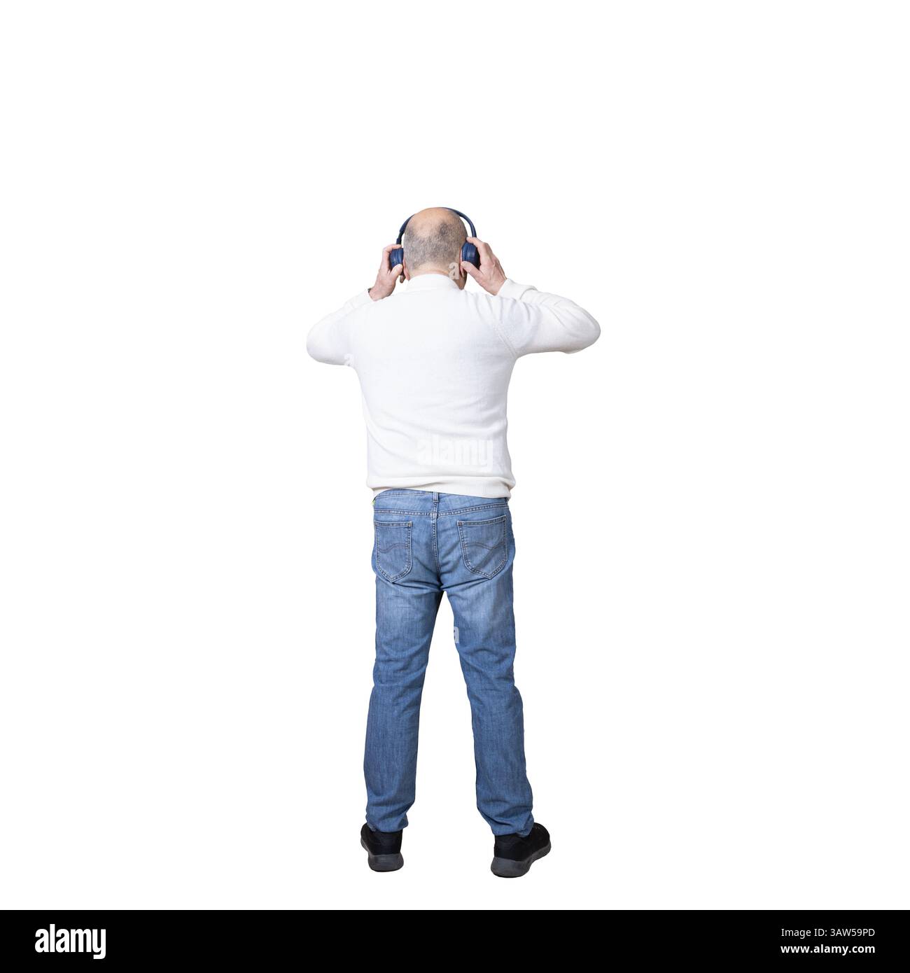 un homme debout avec une paire d'écouteurs sur ses oreilles sur un fond transparent Banque D'Images