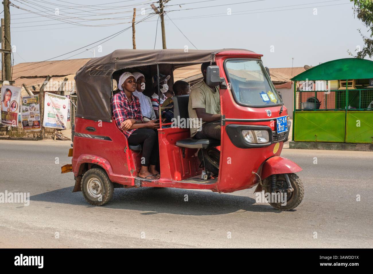 Ghana, Kumasi. Passagers dans le transport en taxi à trois roues. Banque D'Images