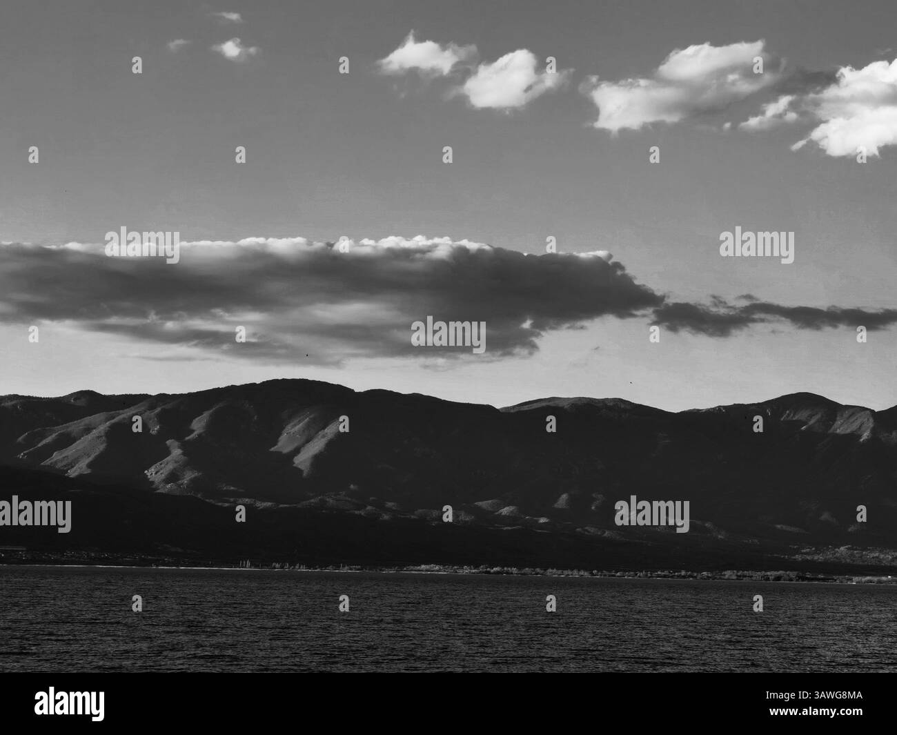 Majesté monochrome : nuages au-dessus de la montagne et du lac Banque D'Images