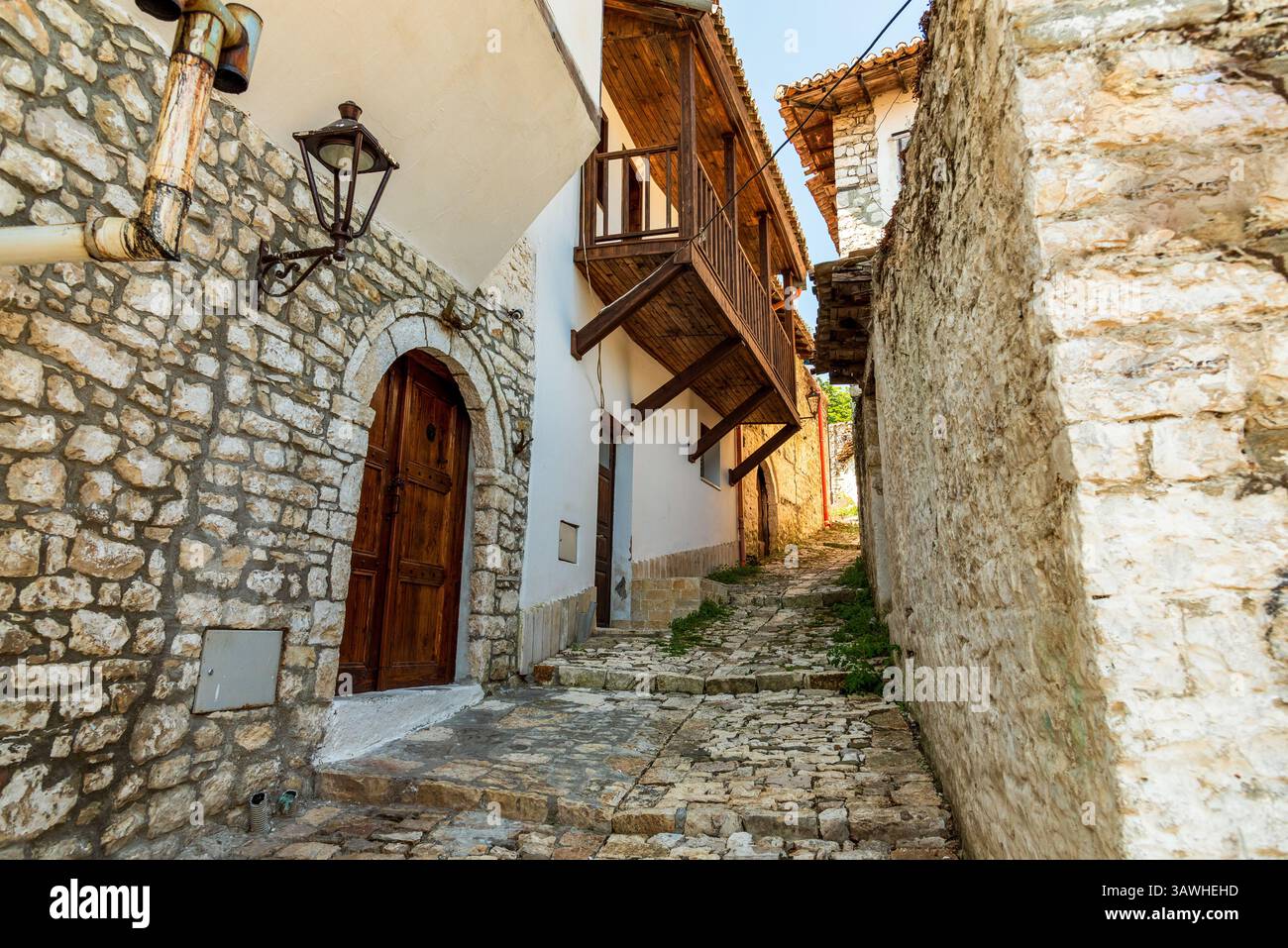 Dans la Lagja e Kalasë (quartier du château) de Berat, les murs de calcaire et les balcons en bois sculptés reflètent des siècles d’héritage albanais le long d’une étroite pierre la Banque D'Images