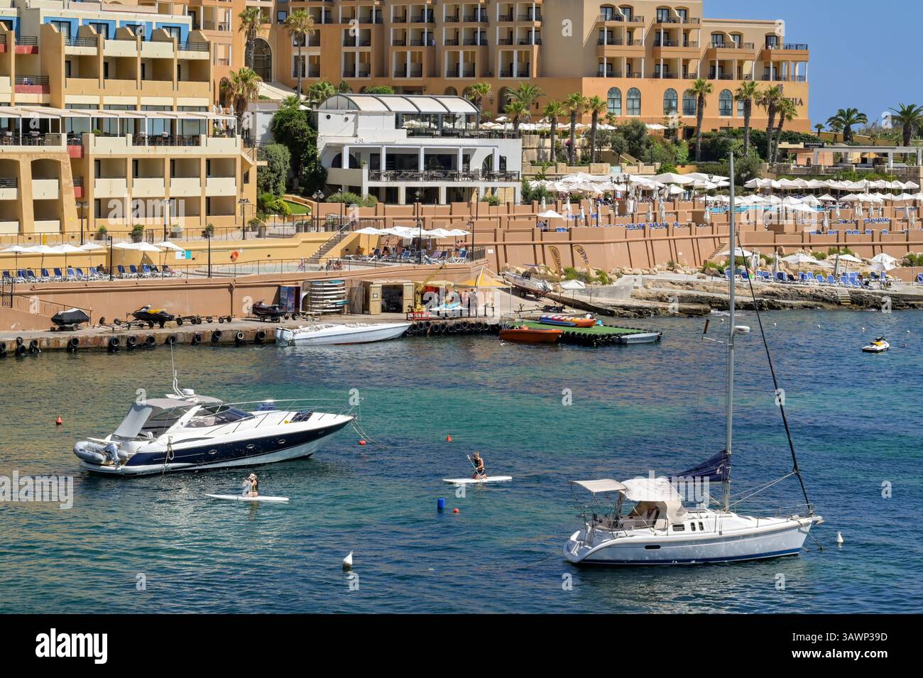 St Julian's, Malte - 2 août 2023 : vue panoramique sur un bateau à moteur et un yacht amarrés dans la baie de St George dans la ville de St Julians. Banque D'Images