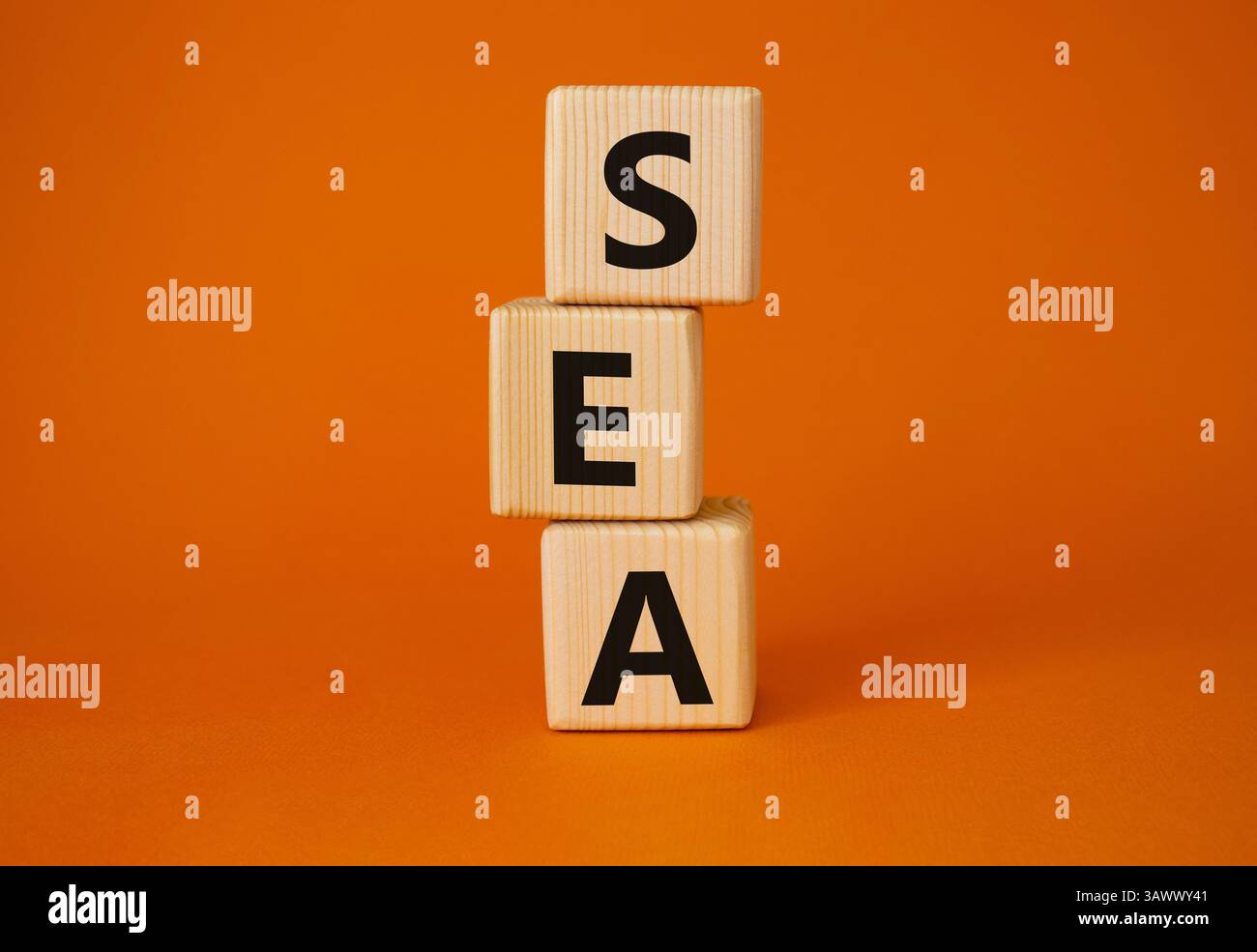 SEA - symbole publicitaire des moteurs de recherche. Cubes en bois avec les mots MER. Beau fond orange. Concept d'affaires et DE MER. Copier l'espace. Banque D'Images
