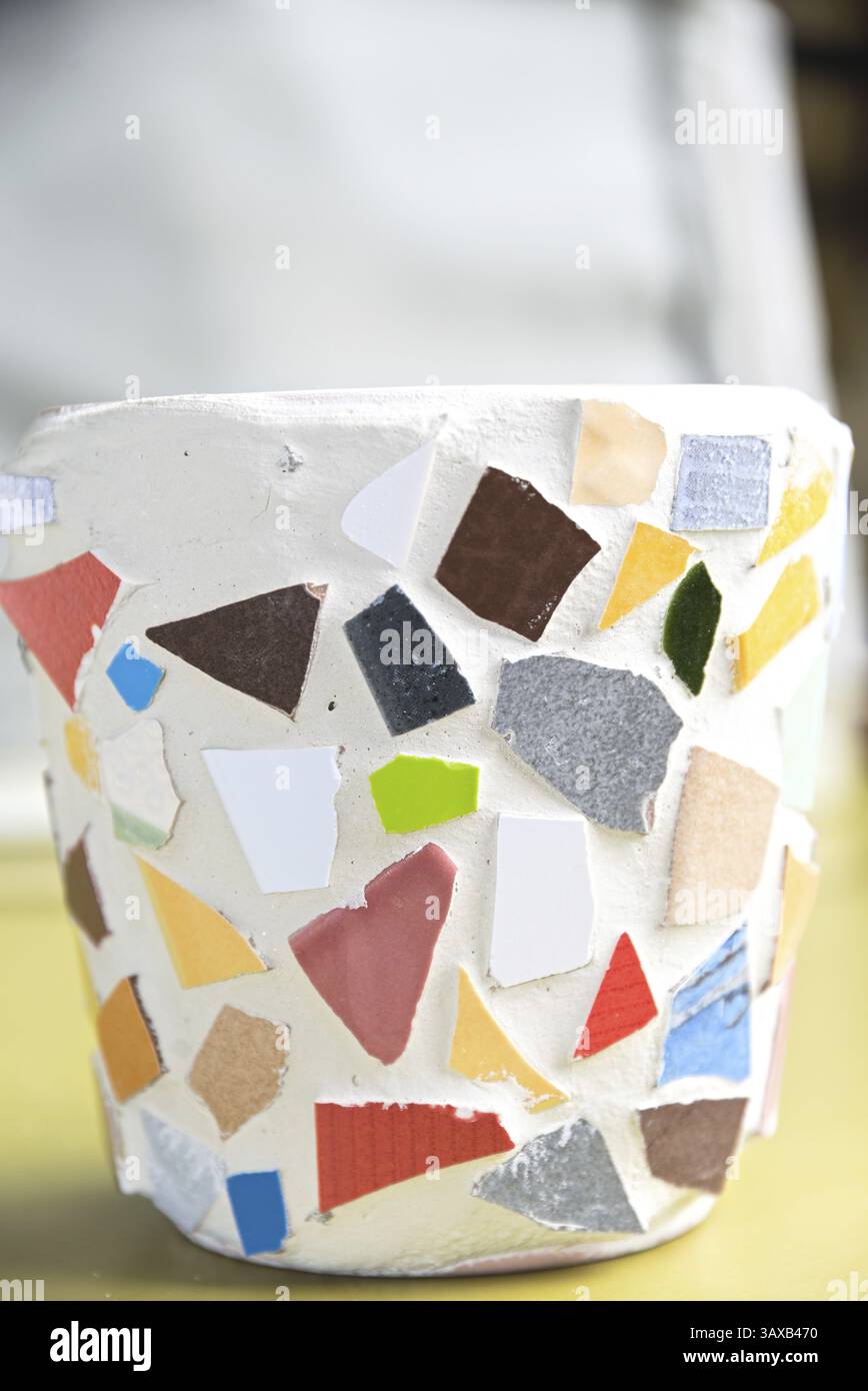 Mosaïque colorée avec des morceaux de tuiles sur un pot de fleurs Banque D'Images