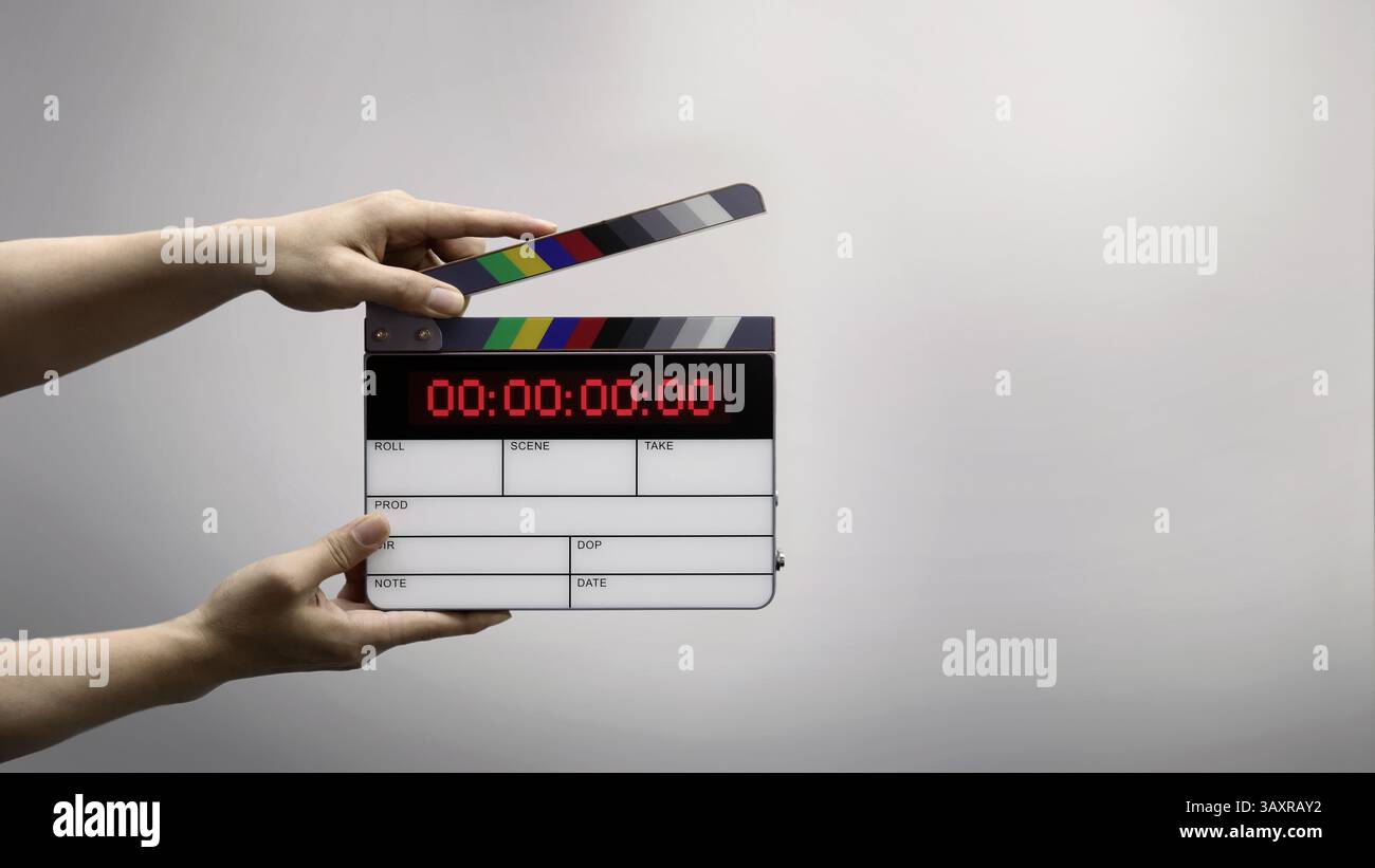 Ardoise de film numérique pour cinéaste dans le set. Main frappant timecode clapet ou ardoise de film pour la production vidéo. Numéro Digi carte de clapet ou film sla Banque D'Images