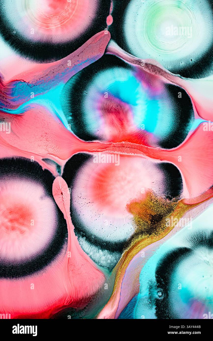 Une pièce d'art abstraite captivante des liquides avec des motifs circulaires audacieux tourbillonnants dans des tons roses, bleus et noirs vibrants. La composition dynamique évoque Banque D'Images