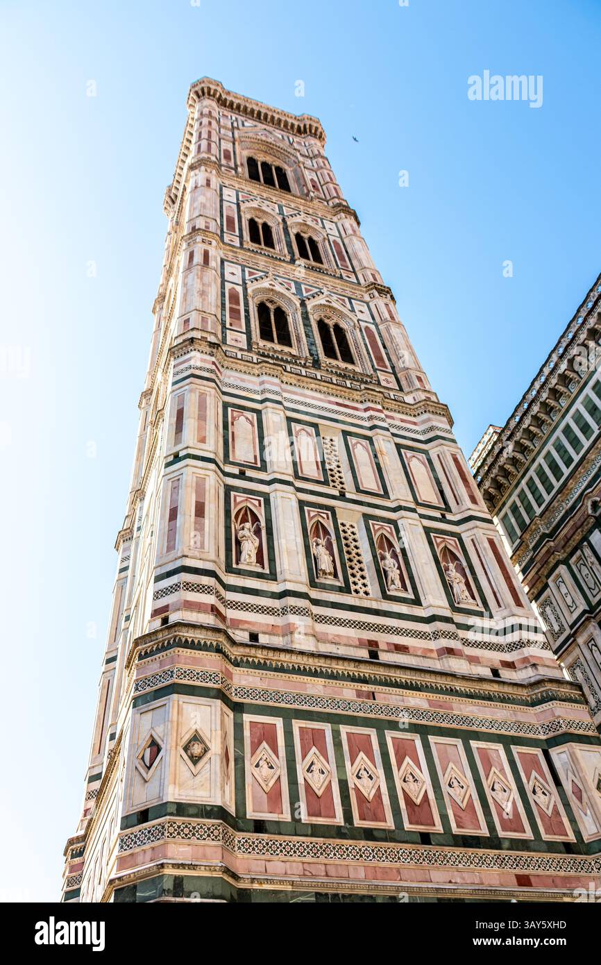 Le Campanile de Giotto, le clocher de la cathédrale de Florence, construit dans un style gothique avec un revêtement en marbre coloré, vu de la Piazza del Duomo. Banque D'Images