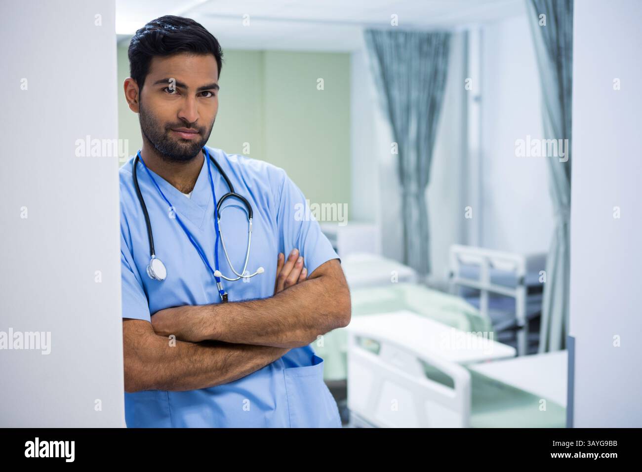 Jeune médecin asiatique debout bras croisés dans la chambre d'hôpital avec stéthoscope, espace copie Banque D'Images