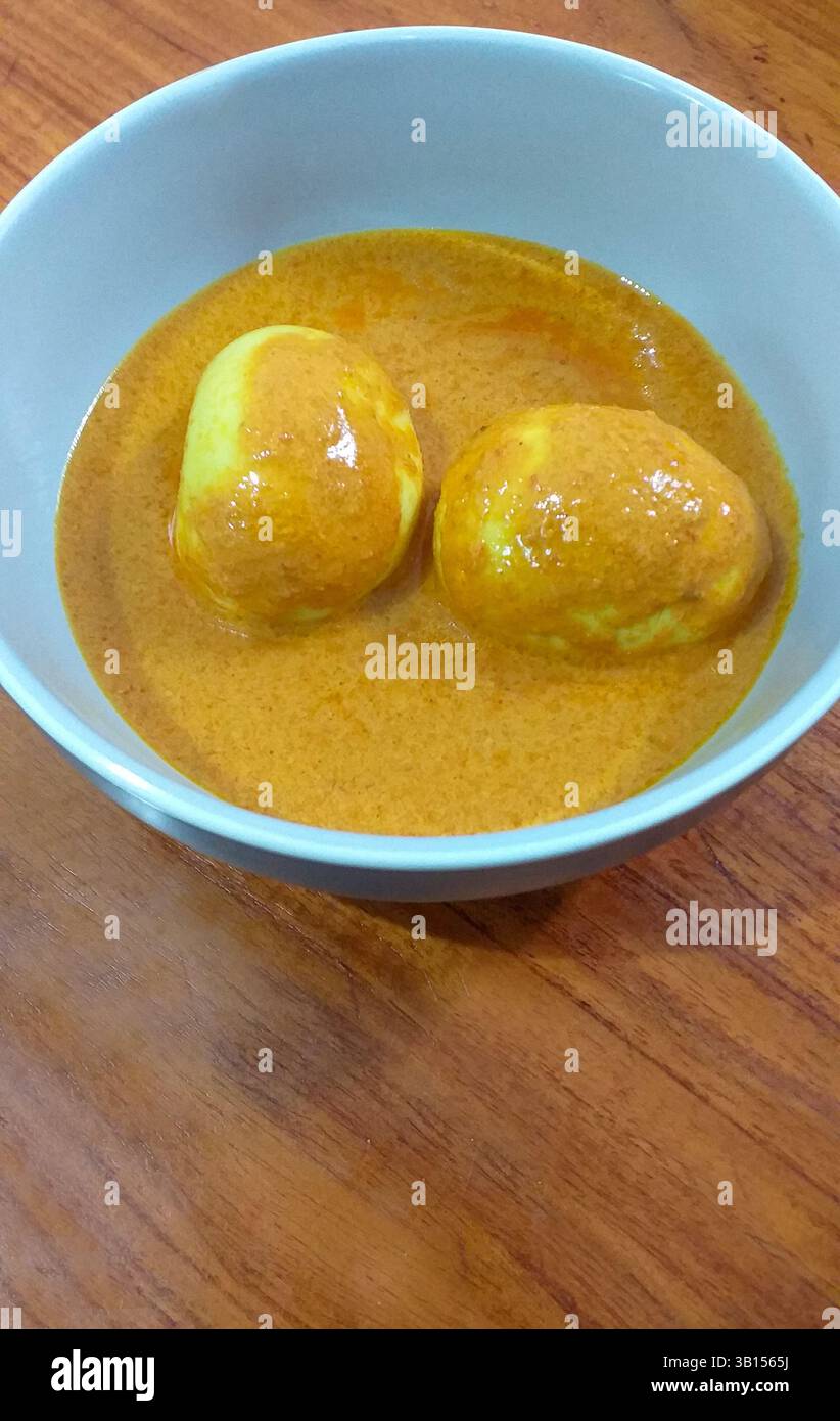 Gulai Telur ou œufs durs en sauce curry douce, nourriture indonésienne Minangkabau Padang de l'ouest de Sumatra. Banque D'Images