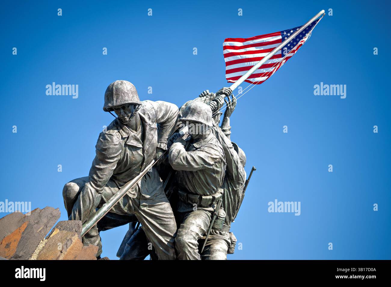 ARLINGTON, États-Unis — le Mémorial de guerre du corps des Marines (également connu sous le nom de Mémorial Iwo Jima) est dessiné contre un soleil brillant et un ciel bleu clair à Arlington, en Virginie. L'emblématique statue en bronze représente six Marines levant le drapeau américain sur le mont Suribachi pendant la bataille d'Iwo Jima pendant la seconde Guerre mondiale. Inauguré en 1954, le mémorial a été sculpté par Felix de Weldon et basé sur la célèbre photographie de Joe Rosenthal. Banque D'Images