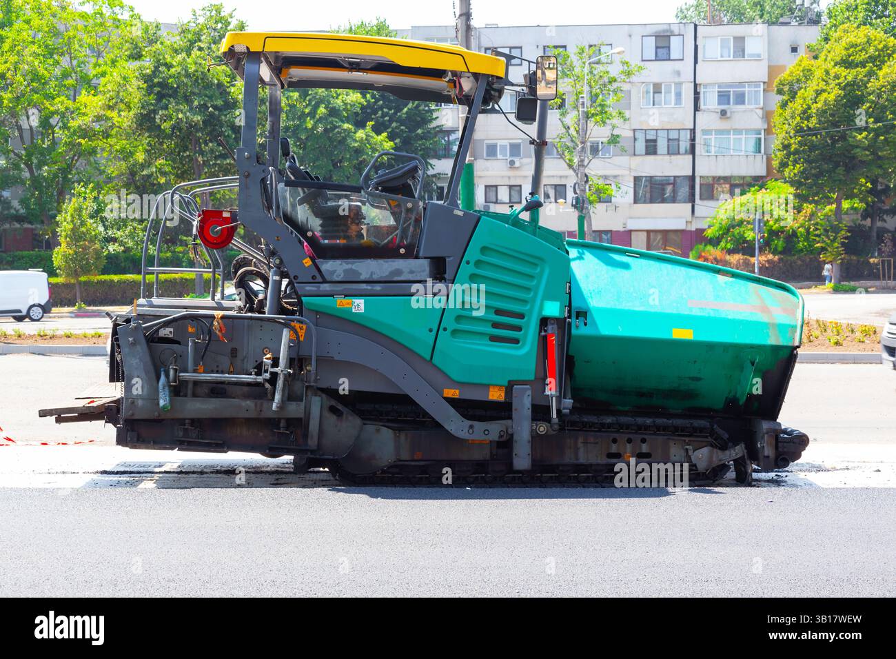 Machine de pavage d'asphalte travaillant sur la pose de l'asphalte neuf sur la route. Banque D'Images