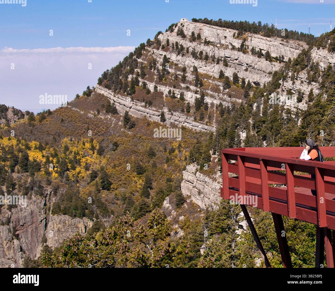 17 oct. 2010 - Albuquerque, Nouveau-Mexique, États-Unis - Un touriste sur la terrasse d'observation voit la face nord-ouest escarpée et accidentée des montagnes Sandia, à son sommet la cabane Kiwanis, construite par le CCC en 1936, et restaurée en 1995 après les dommages causés par le feu et le vent, photographiée depuis le pic Sandia de 3 163 m de haut dans la forêt nationale de Cibola sur la bordure orientale d'Albuquerque, au Nouveau-Mexique. (Crédit image : © Arnold Drapkin/ZUMAPRESS.com) Banque D'Images