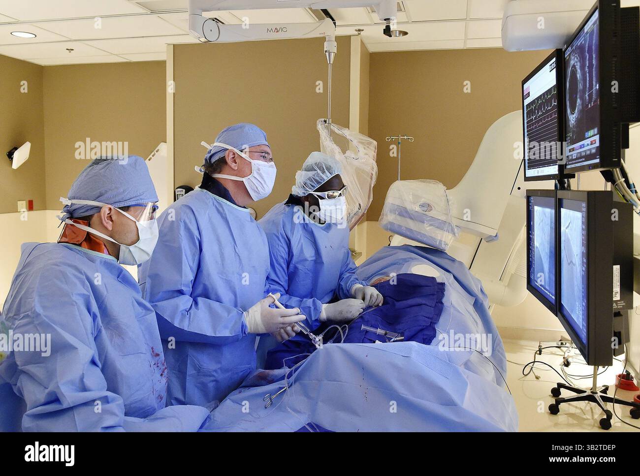 25 novembre 2015 - Kansas City, MO, États-Unis - Kenneth Huber, au milieu, cardiologue interventionnel au Saint Luke's Mid America Heart Institute, déploie un stent coronaire dans l'artère fémorale d'un patient dont l'artère est bloquée le 25 novembre 2015. Huber aidait Abdel-Karim Abdul-Rahman, à gauche, et Clarence Findley, un collègue interventionnel. (Crédit image : © Jill Toyoshiba/TNS via ZUMA Wire) Banque D'Images 25 novembre 2015 - Kansas City, MO, États-Unis - Kenneth Huber, au milieu, cardiologue interventionnel au Saint Luke's Mid America Heart Institute, déploie un stent coronaire dans l'artère fémorale d'un patient dont l'artère est bloquée le 25 novembre 2015. Huber aidait Abdel-Karim Abdul-Rahman, à gauche, et Clarence Findley, un collègue interventionnel. (Crédit image : © Jill Toyoshiba/TNS via ZUMA Wire) Banque D'Images