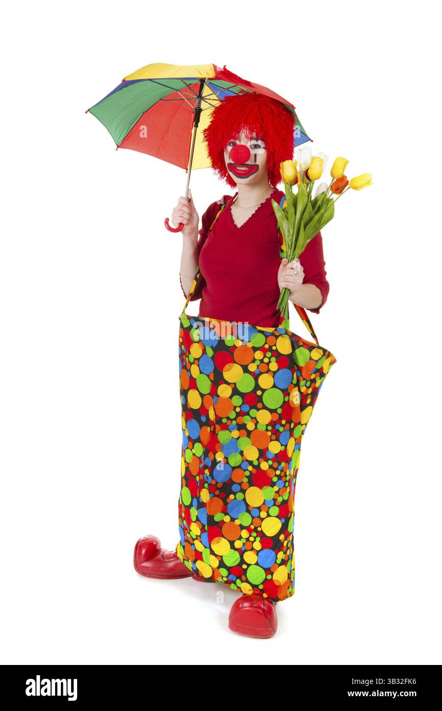 Funny clown avec fleurs et parapluie dans le studio Banque D'Images