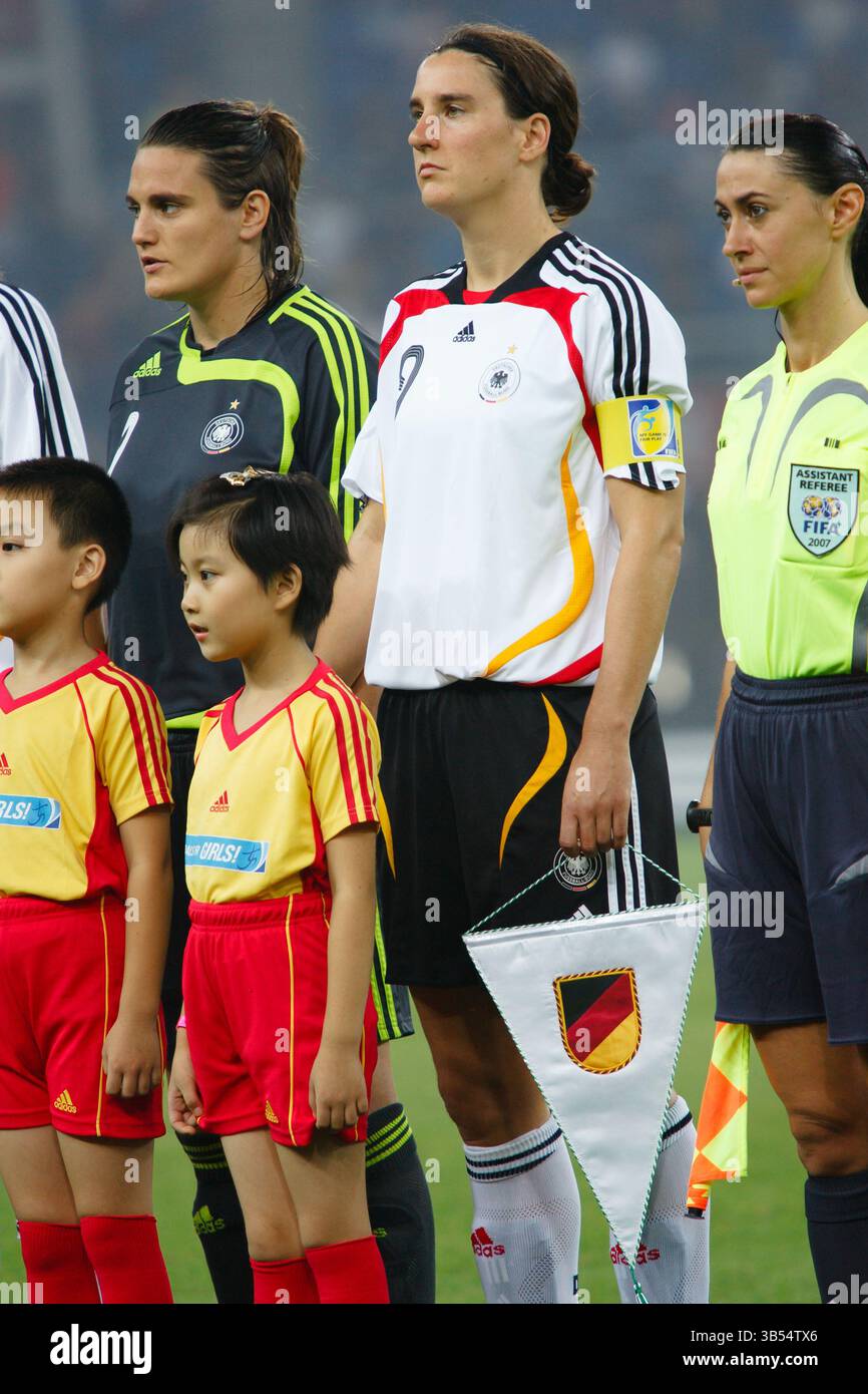 La capitaine allemande Birgit Prinz tient un fanion d'équipe alors qu'elle se présente pour l'hymne national avant un match de demi-finale de la Coupe du monde féminine de la FIFA contre la Norvège au stade du Centre sportif olympique de Tianjin le 26 septembre 2007 à Tianjin, en Chine. Usage éditorial exclusif. Utilisation commerciale interdite. Pas de poussée vers l'utilisation d'un appareil mobile. (Photographie de Jonathan Paul Larsen / Diadem images) Banque D'Images