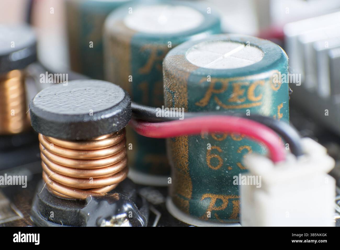 Composants informatiques poussiéreux. Détail d'une carte mère d'ordinateur poussiéreuse. Condensateur électrolytique et conducteur visibles sur la carte de circuit imprimé. Sélectiv Banque D'Images