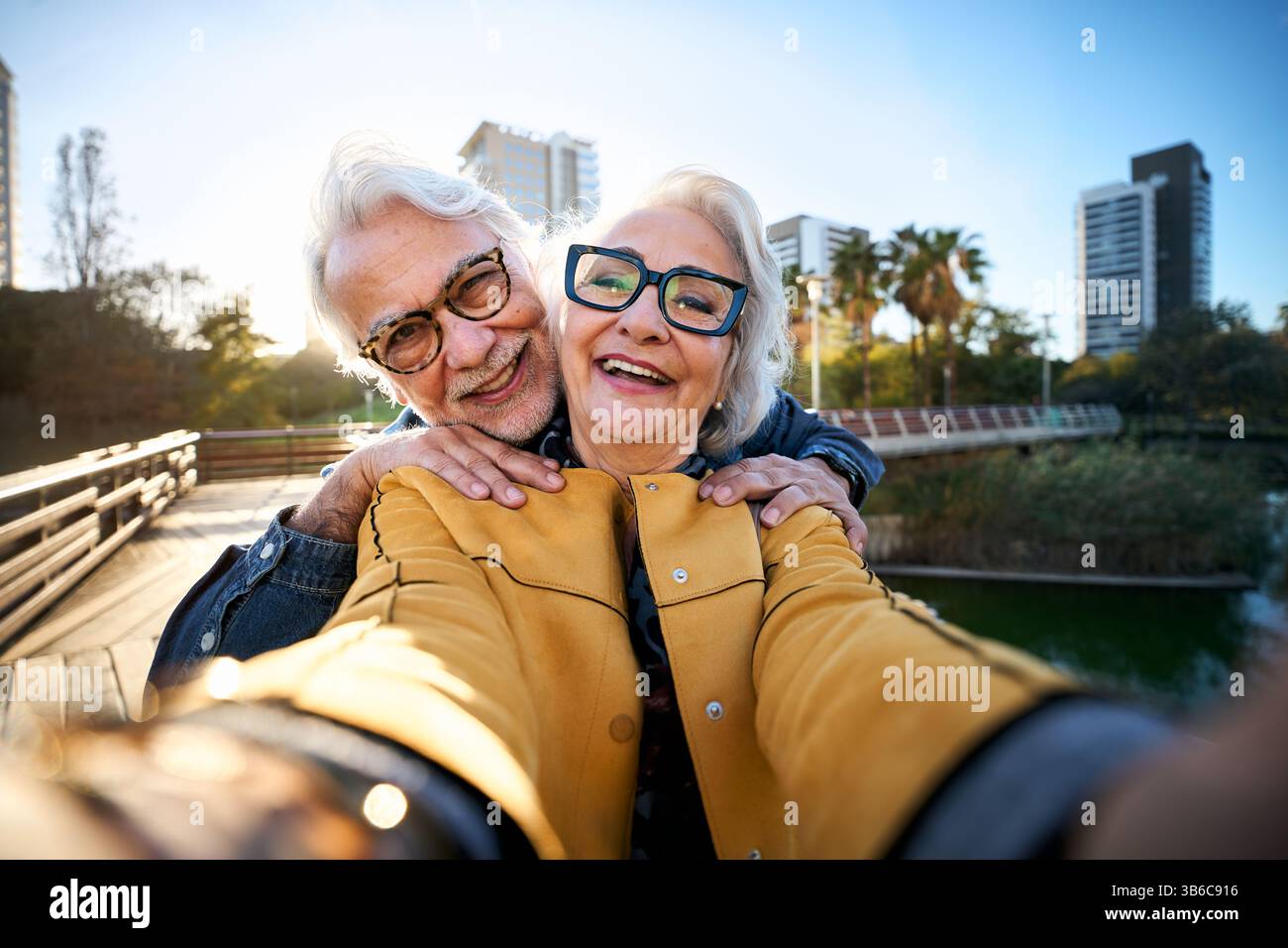 Heureux couple senior prenant un selfie dans le parc de la ville Banque D'Images