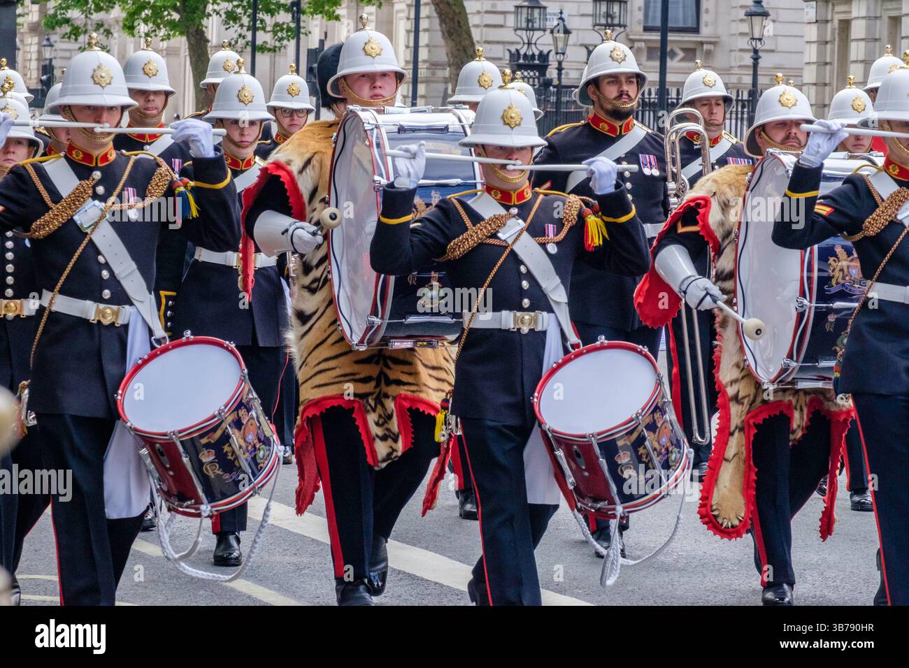5 mai 2025, Londres, Royaume-Uni. Commémoration de la Journée VE. Un défilé de militaires britanniques et internationaux a lieu dans le centre de Londres pour marquer le 80e anniversaire de la fin de la seconde Guerre mondiale en Europe. Sur la photo : les groupes des Royal Marines de sa Majesté se produisent le long de la route lors de la procession commémorative du VE Day dans le centre de Londres. Banque D'Images