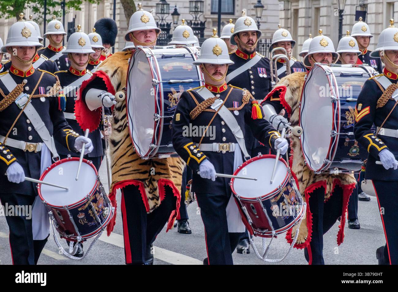 5 mai 2025, Londres, Royaume-Uni. Commémoration de la Journée VE. Un défilé de militaires britanniques et internationaux a lieu dans le centre de Londres pour marquer le 80e anniversaire de la fin de la seconde Guerre mondiale en Europe. Sur la photo : les groupes des Royal Marines de sa Majesté se produisent le long de la route lors de la procession commémorative du VE Day dans le centre de Londres. Banque D'Images