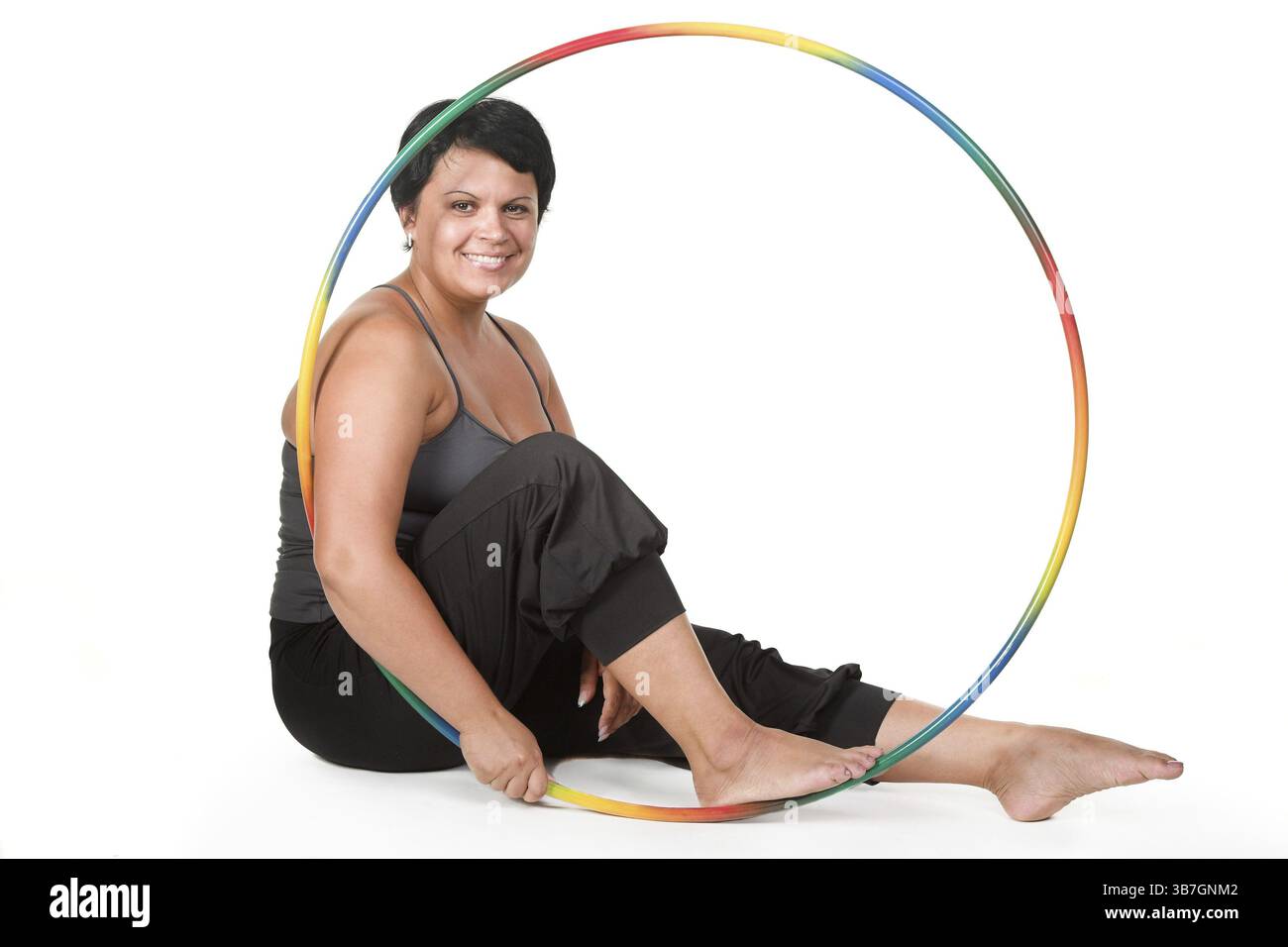 Grosse femme avec des cerceaux de hula Banque D'Images