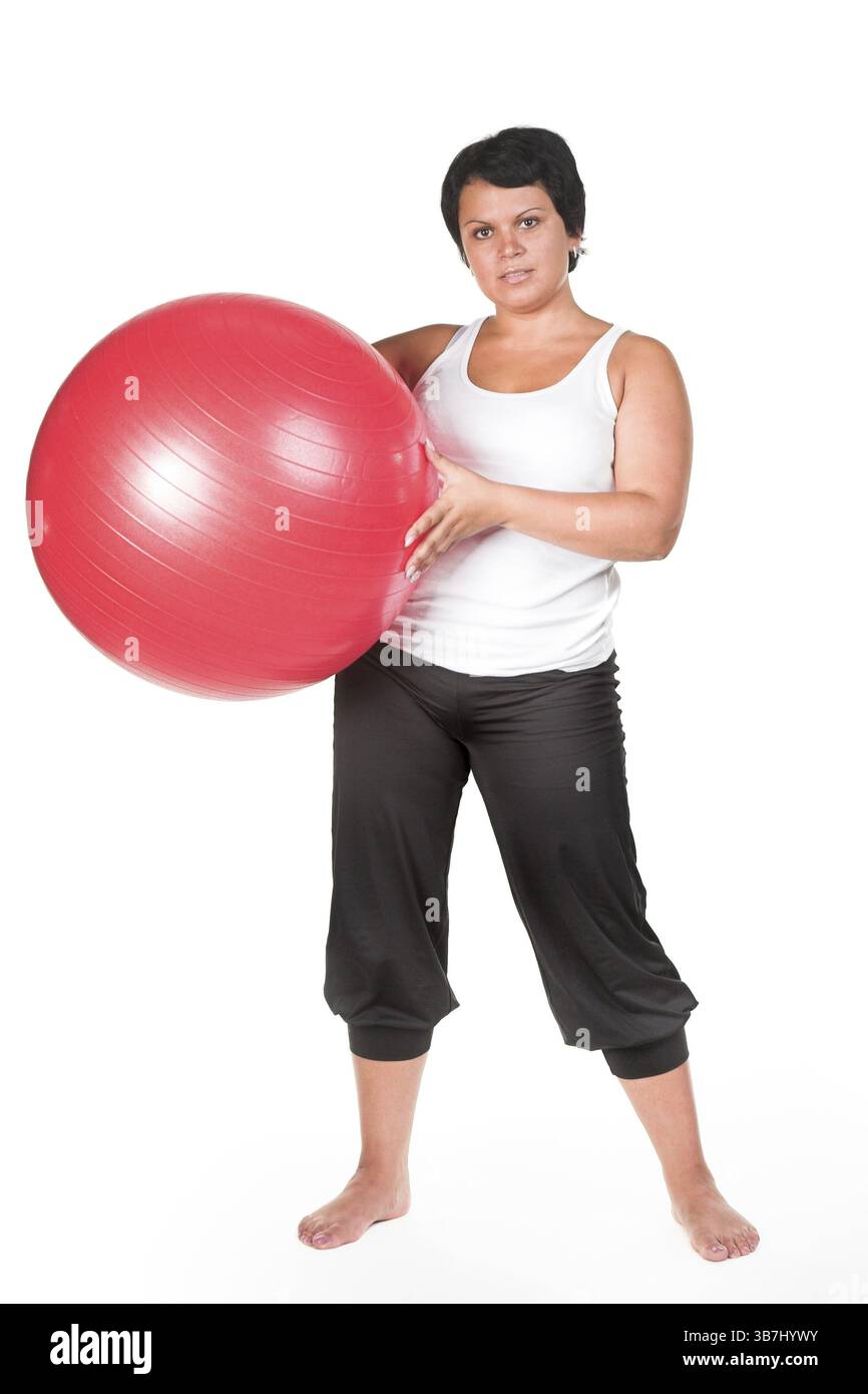 Grosse femme avec une grosse boule rouge Banque D'Images