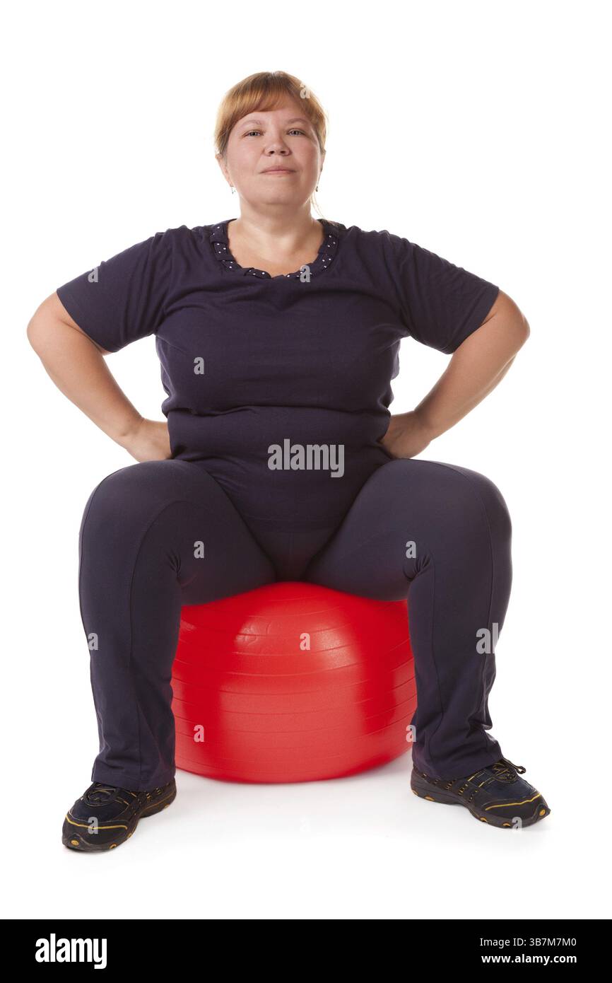 Grosse femme avec une grosse boule cardan rouge Banque D'Images