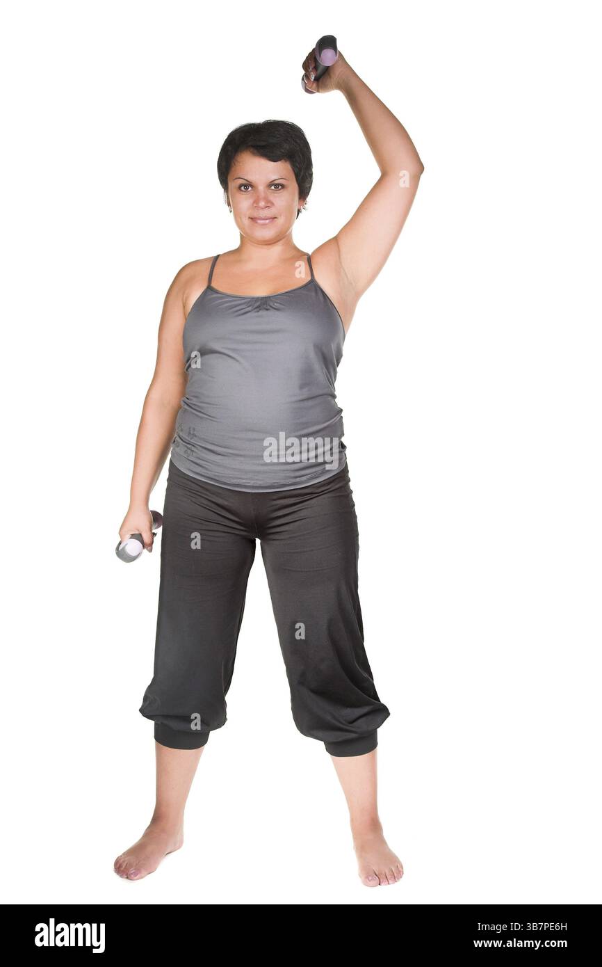 Grosse femme entraînement avec haltères Banque D'Images