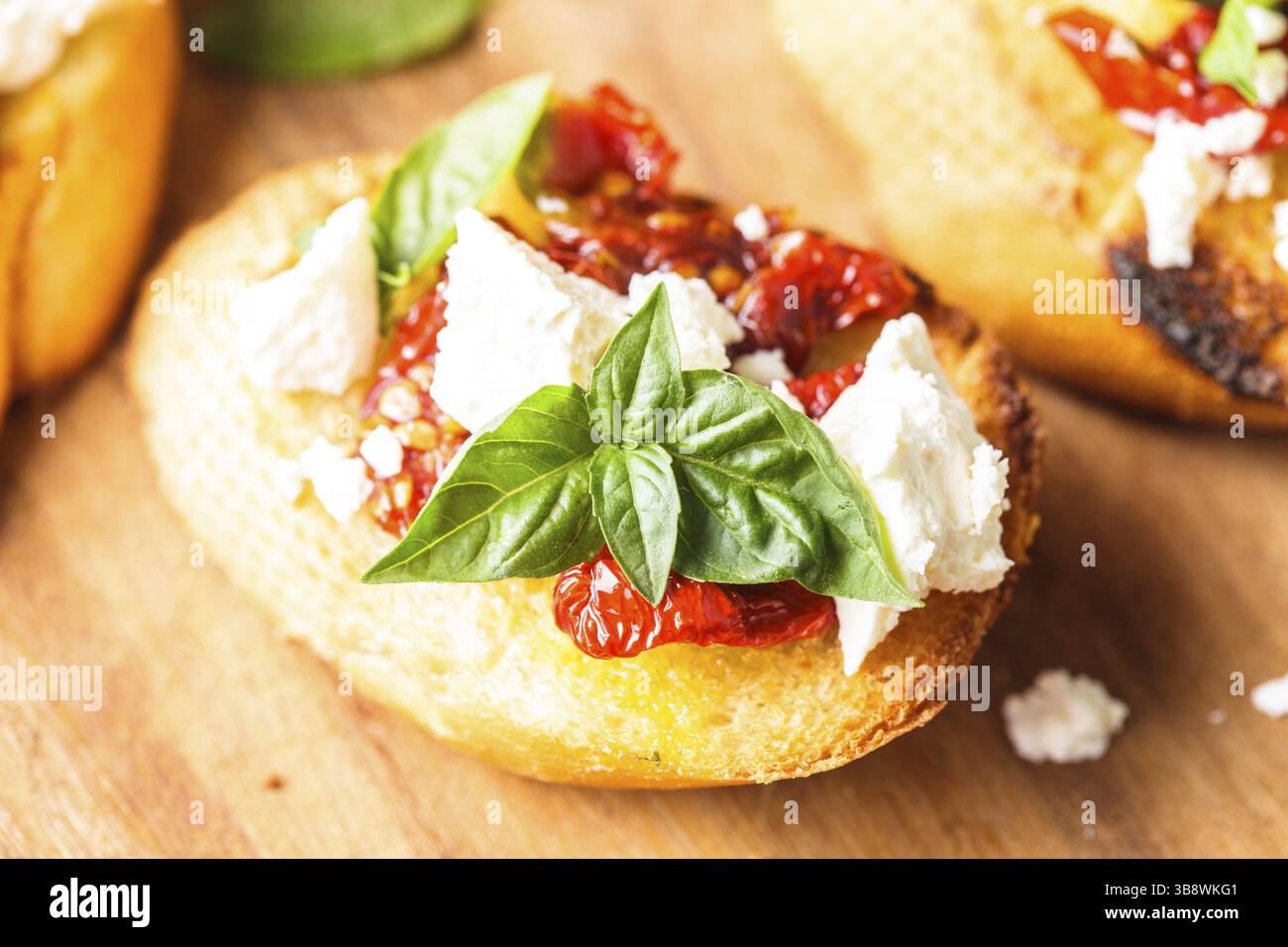 Bruschetta à l'huile d'olive, tomates séchées, feta et basilic frais Banque D'Images Bruschetta à l'huile d'olive, tomates séchées, feta et basilic frais Banque D'Images