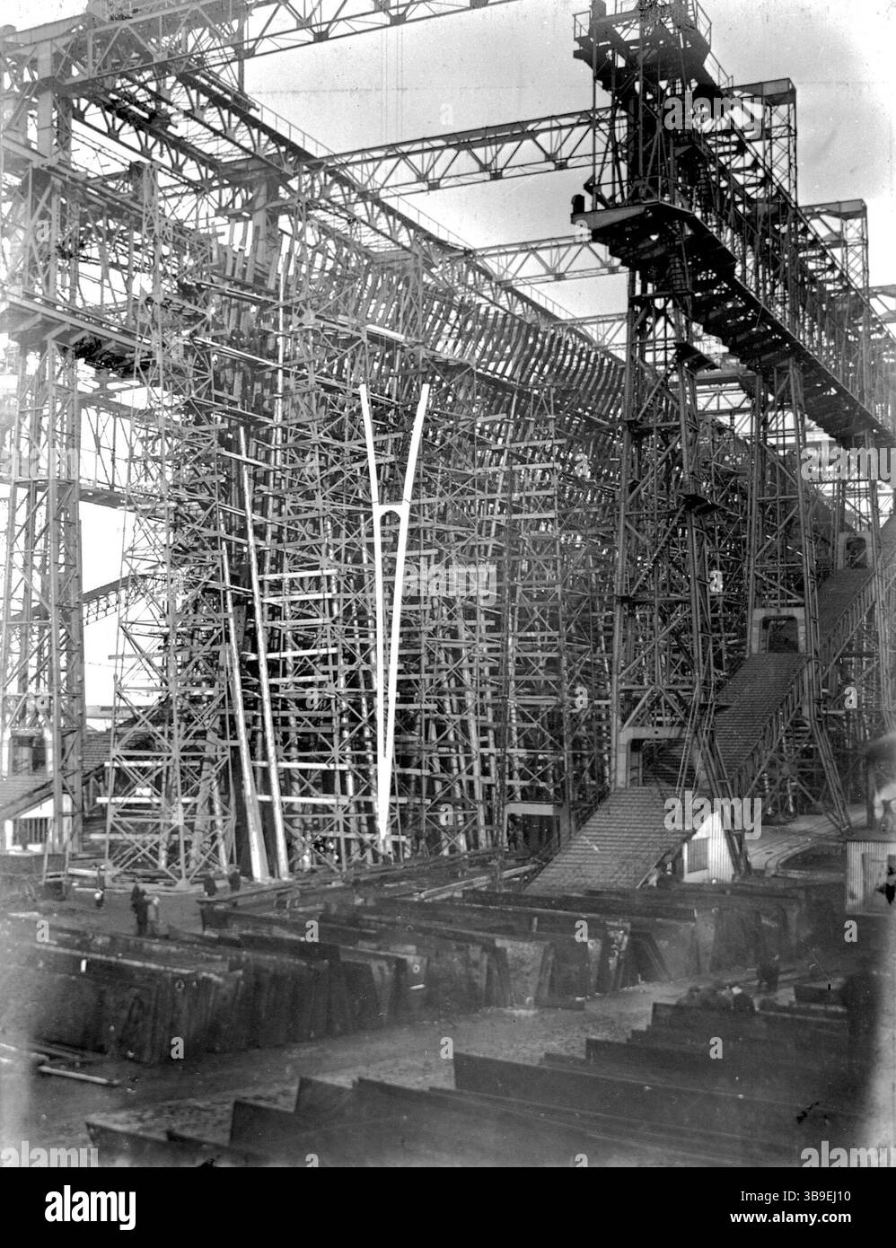 Titanic est mondialement célèbre maintenant, mais à l'époque son navire jumeau Olympic était une grande nouvelle, car il a été lancé 6 mois plus tôt et était donc le plus grand paquebot du monde. En conséquence, il y a beaucoup de photos d'Olympic et pas beaucoup de Titanic. Comme les townships étaient identiques, les images d'Olympic servent parfaitement d'illustration du Titanic. Cela montre l'énorme échafaudage nécessaire pour construire ces navires. Il s'agit de l'arc d'Olympic daté du 20 novembre 1909. Banque D'Images