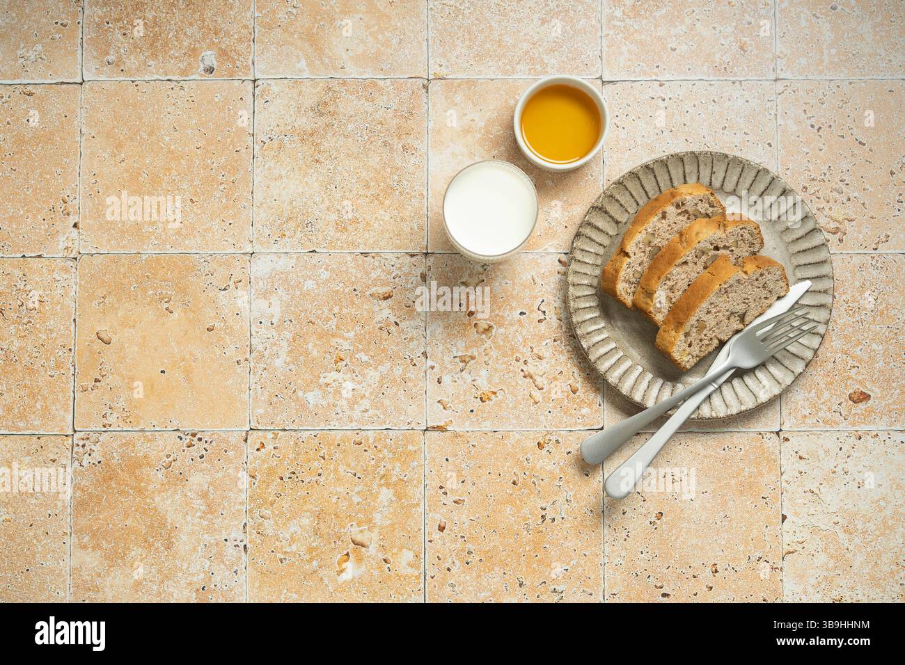 Petit déjeuner avec pain grillé, confiture et lait sur fond de tuile. Banque D'Images