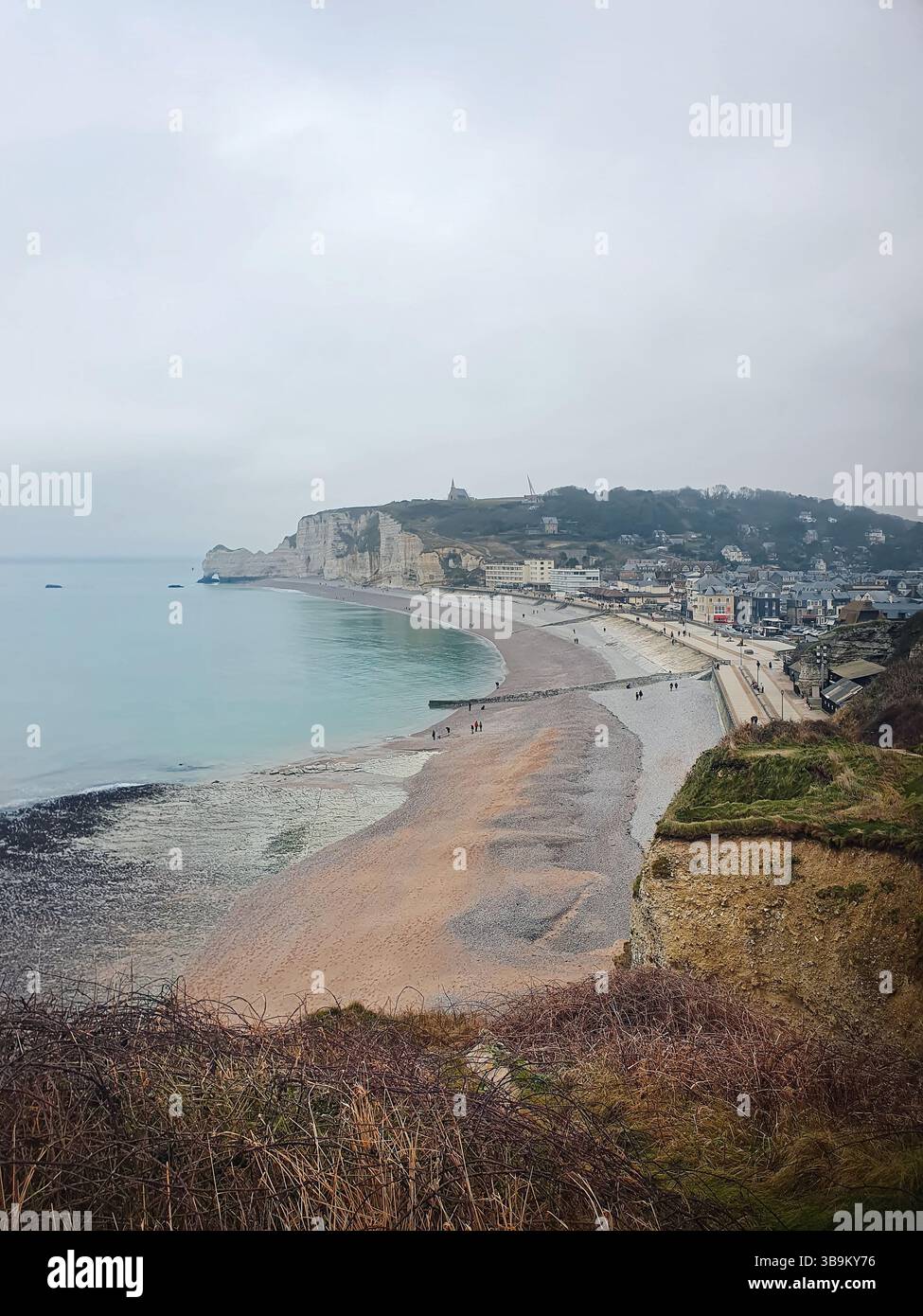Ville côtière d'Etretat avec une plage de galets, des falaises et une mer calme. Les célèbres falaises de falaise d'aval en Normandie, France Banque D'Images