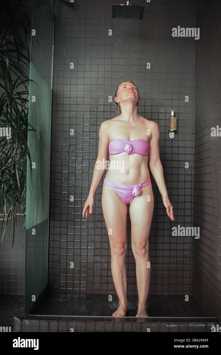 Jeune femme se lavant les cheveux avec shanpoo dans la douche. Banque D'Images