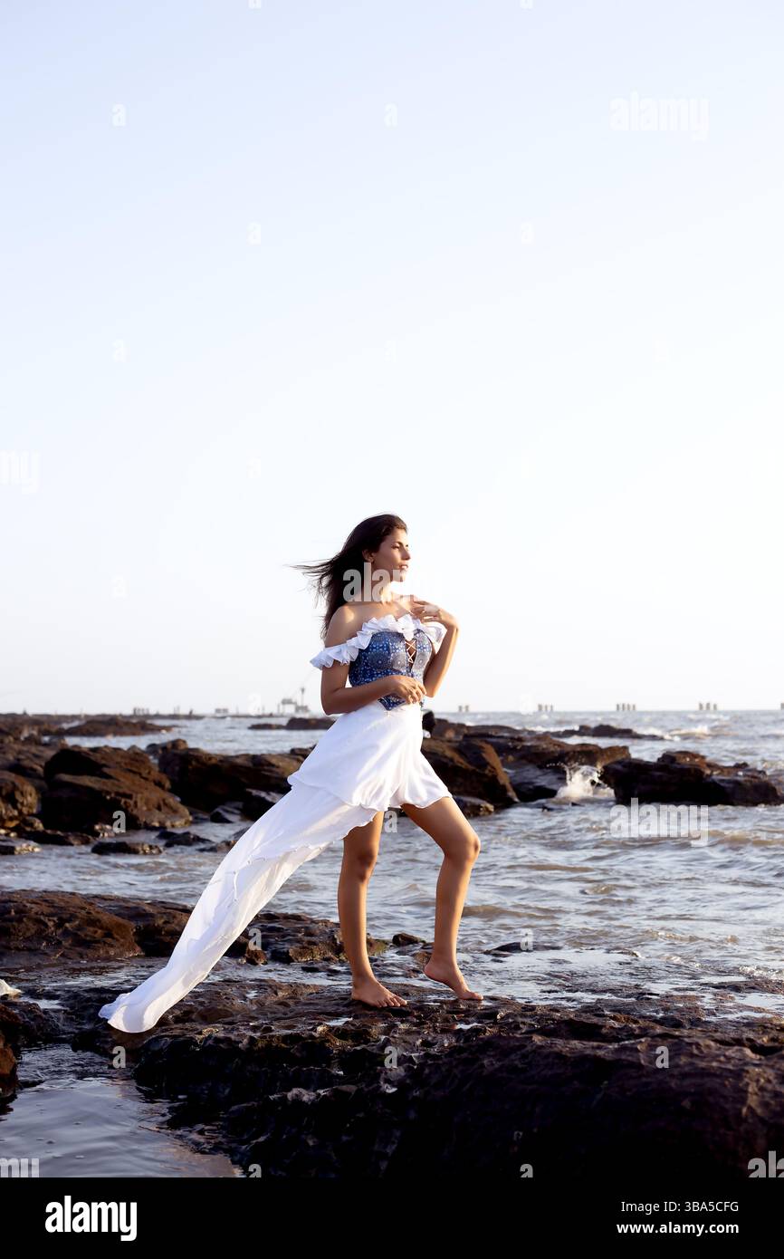 Belle jeune femme à une plage dans une robe féminine Banque D'Images