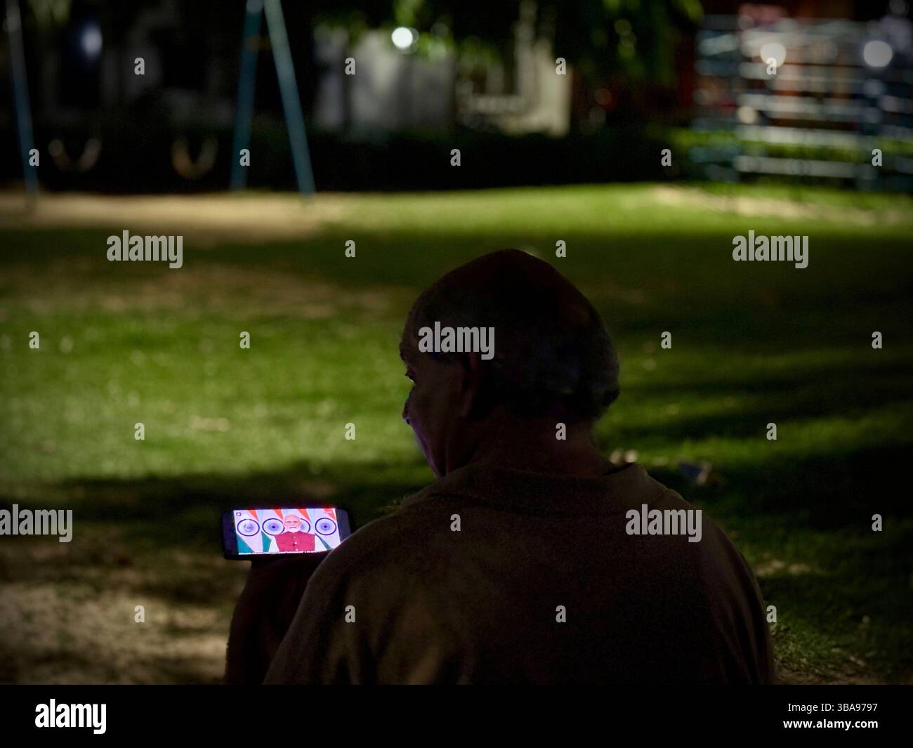 A man watches the live telecast of Indian Prime Minister Narendra Modi ...