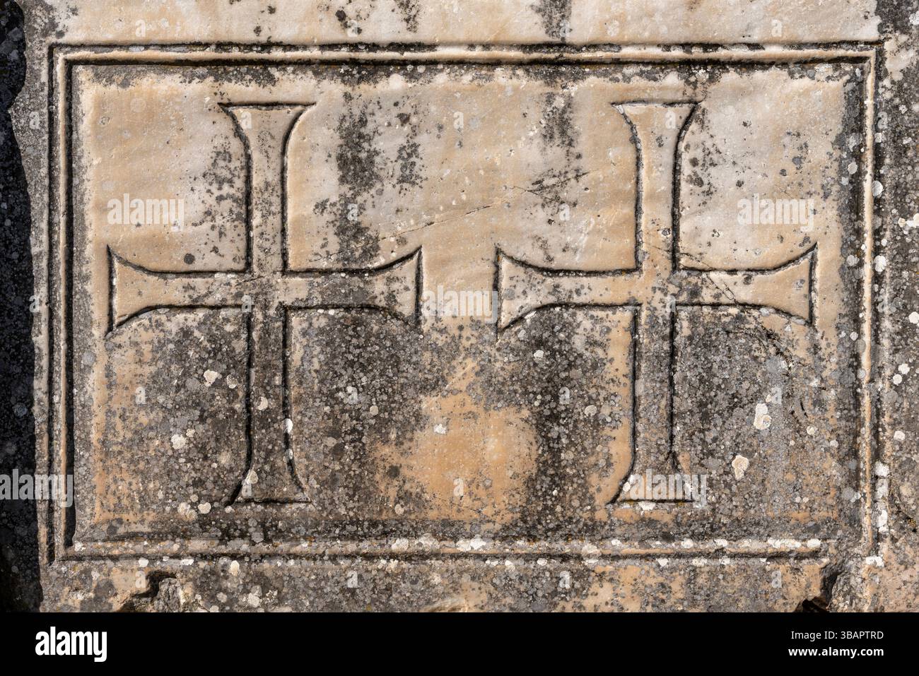 Sculptures de croix byzantines sur un mur de marbre à Éphèse, vestiges des périodes chrétiennes postérieures superposés sur des pierres architecturales romaines. Banque D'Images