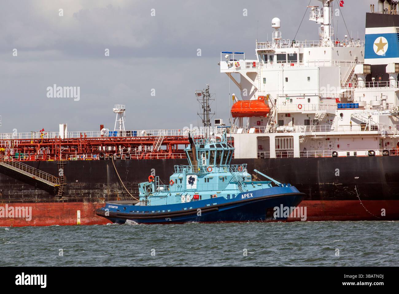 Southampton, Hampshire, Royaume-Uni - 22 avril 2025 : remorqueur Apex sur Southampton Water travaillant avec un gros pétrolier à Fawley Banque D'Images