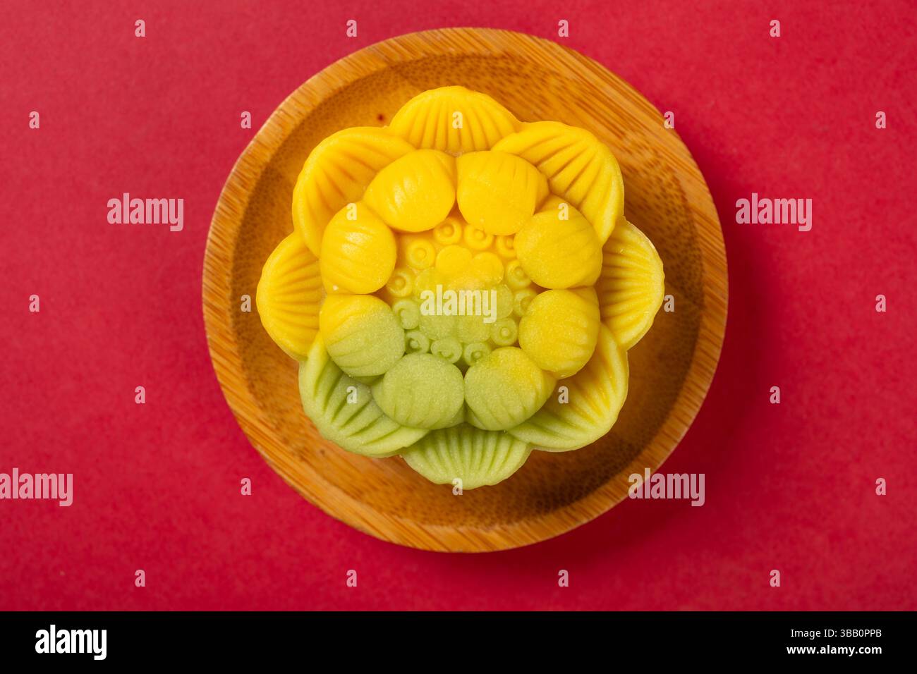 vue de dessus forme de fleur jaune mooncake sur rouge Banque D'Images