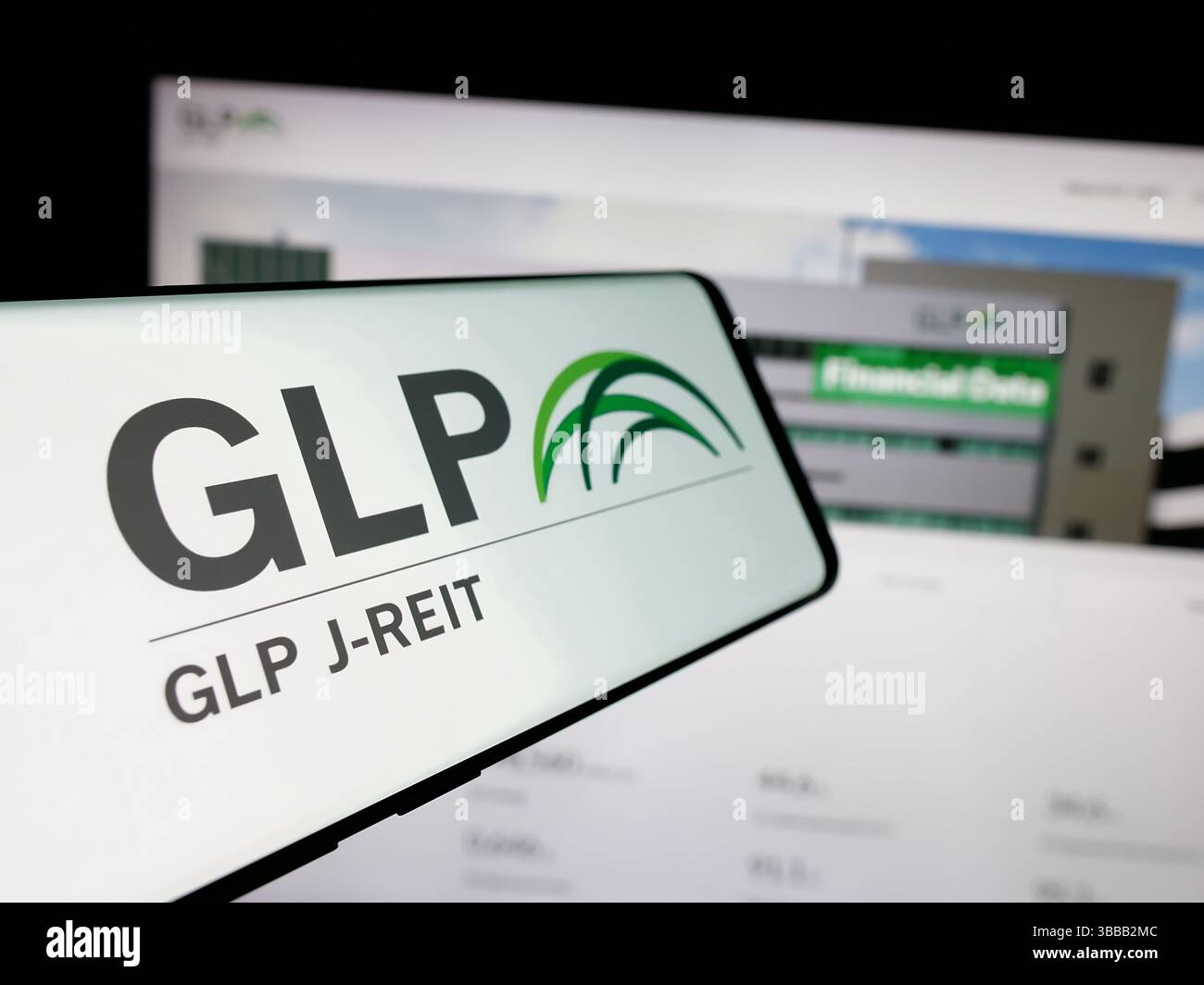 Stuttgart, Allemagne - 01-02-2024 : téléphone portable avec le logo de la société immobilière japonaise GLP J-REIT sur l'écran devant le site Web de l'entreprise. Banque D'Images