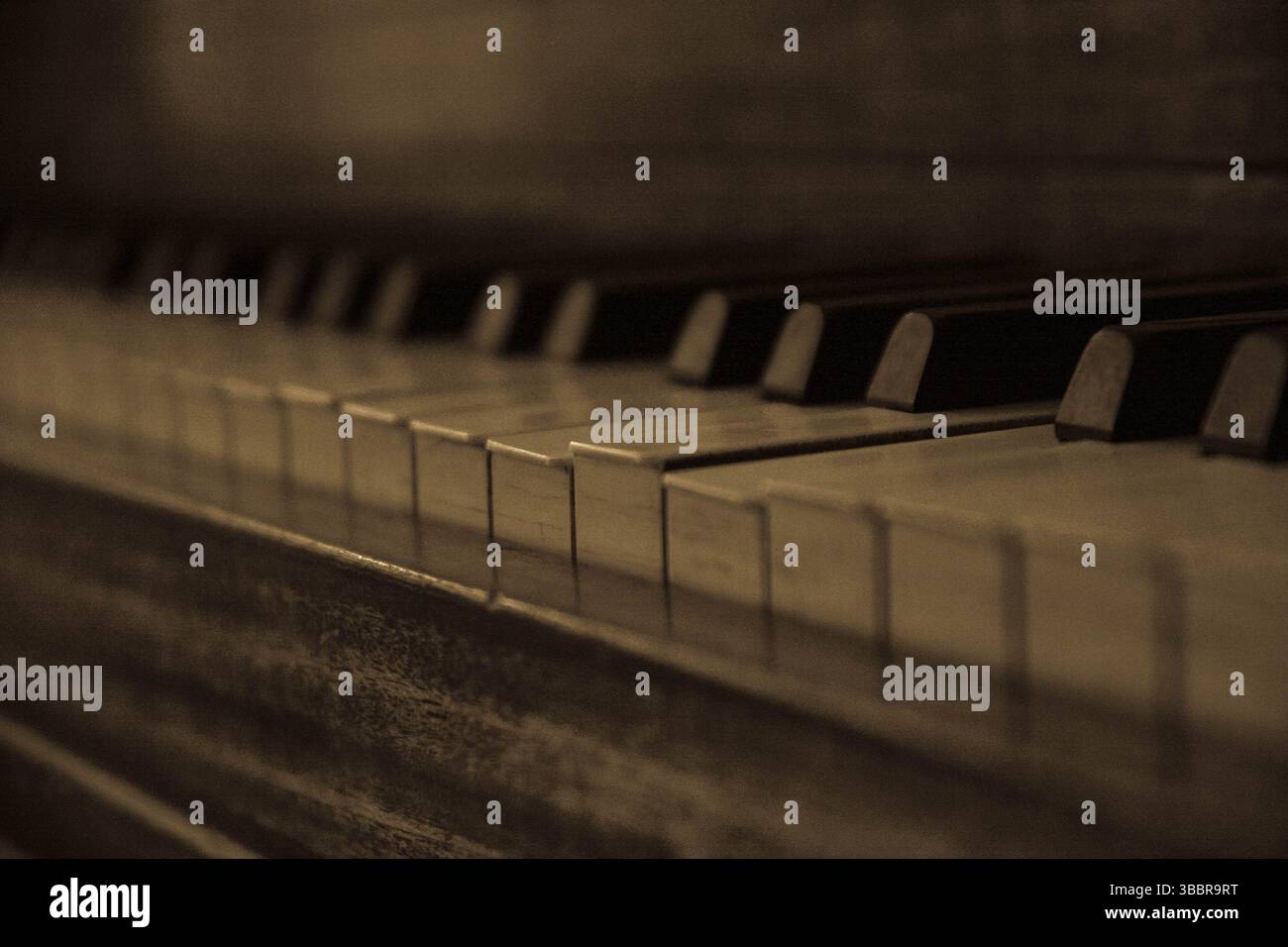 Gros plan sépia de touches de piano vintage avec éclairage tamisé, capturant l'élégance nostalgique et la beauté intemporelle d'un instrument de musique classique Banque D'Images