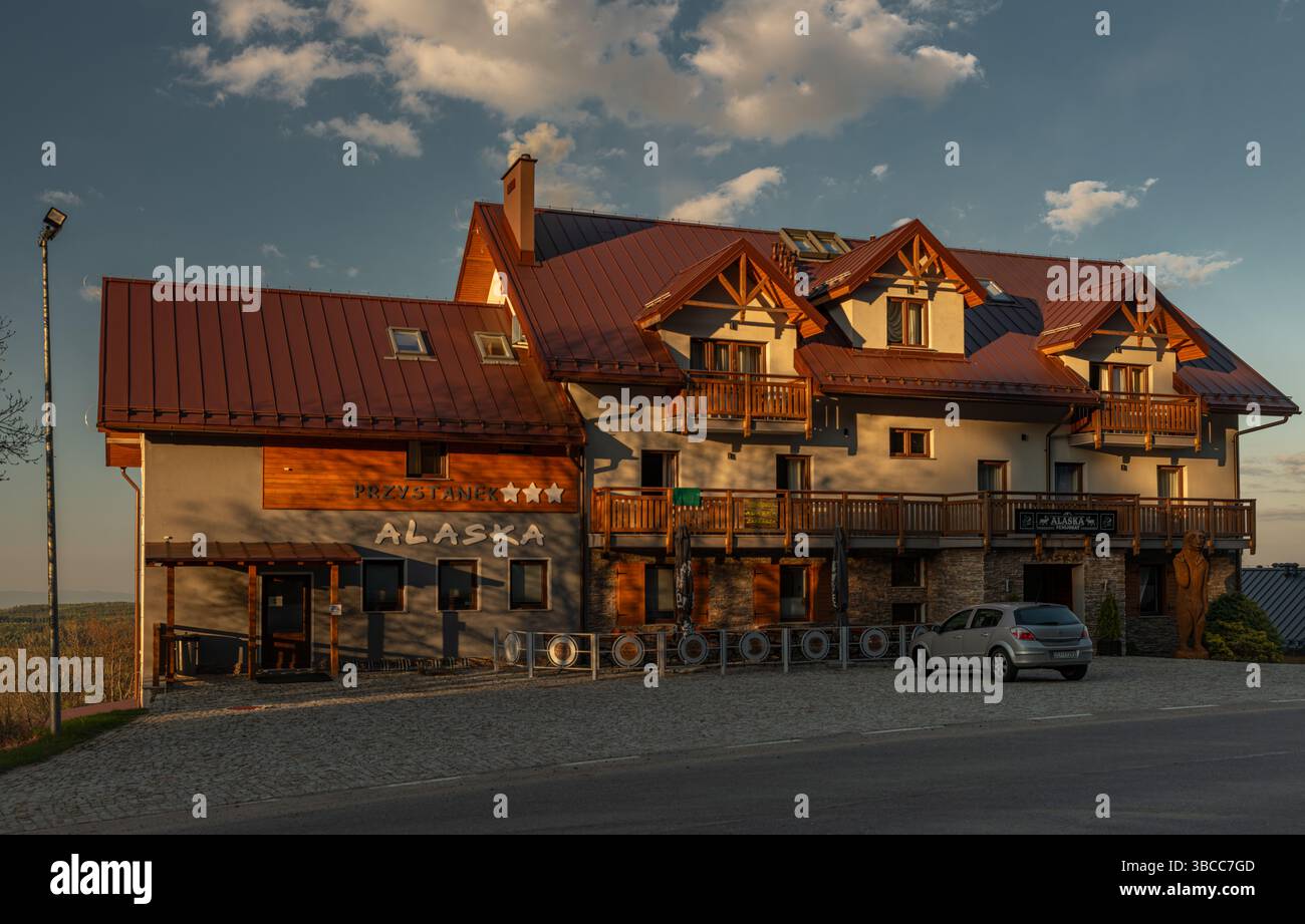 Hôtel en bois sous colline et montagnes Orlicke hory avec coucher de soleil à Zieleniec Pologne 04 28 2025 Banque D'Images