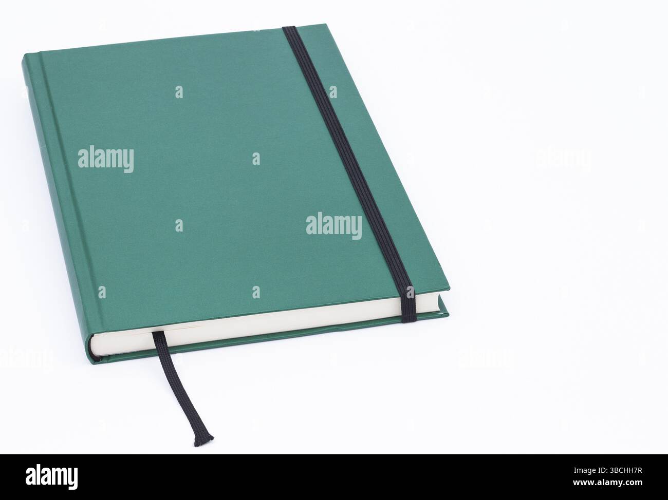 Cahier fermé, vert sur fond blanc Banque D'Images