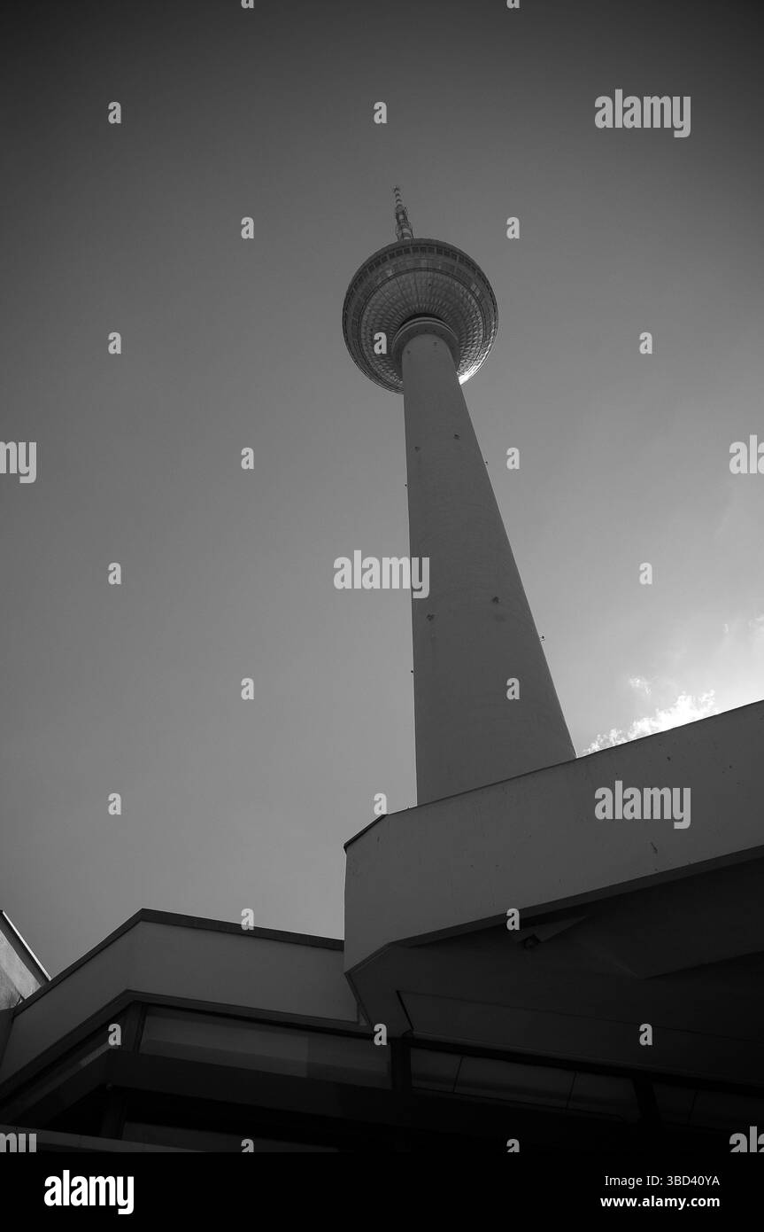 Une vue d'en bas de la célèbre tour de télévision de Berlin, mettant en évidence sa structure imposante contre un ciel lumineux. Banque D'Images