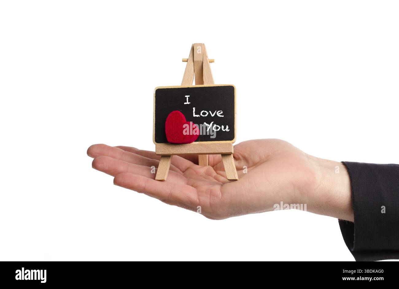 Main tenant un chevalet avec les mots je vous aime !. La Saint-Valentin ou la Fête des Mères, concept Banque D'Images
