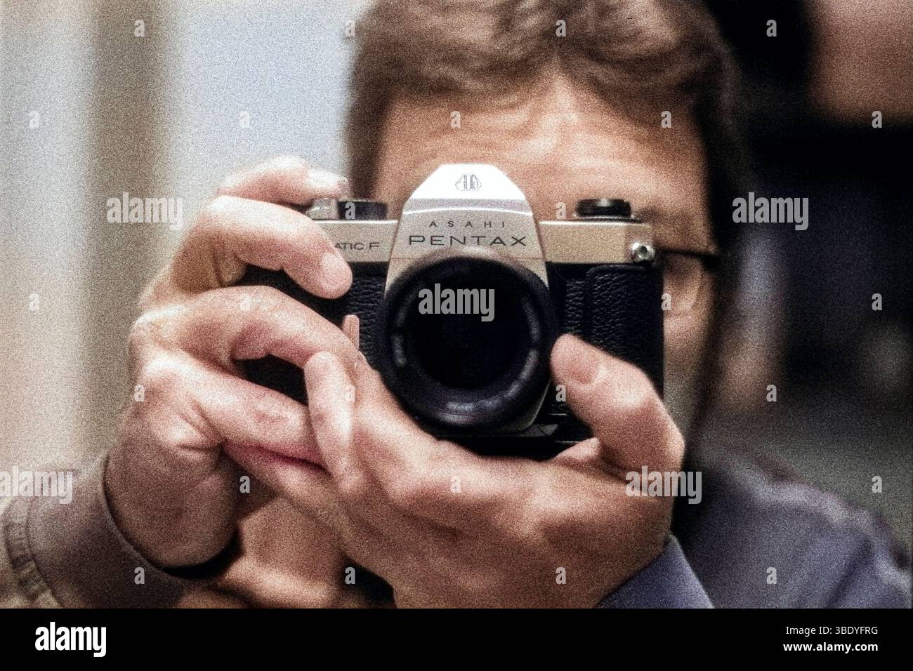 Selfie / Autoportrait d'un homme adulte mature portant des lunettes et utilisant un film analogique Pentax de 50 ans et appareil photo. Tourné sur film analogique noir et blanc, colorisé avec des filtres neuronaux PS. Tilburg, pays-Bas. Banque D'Images