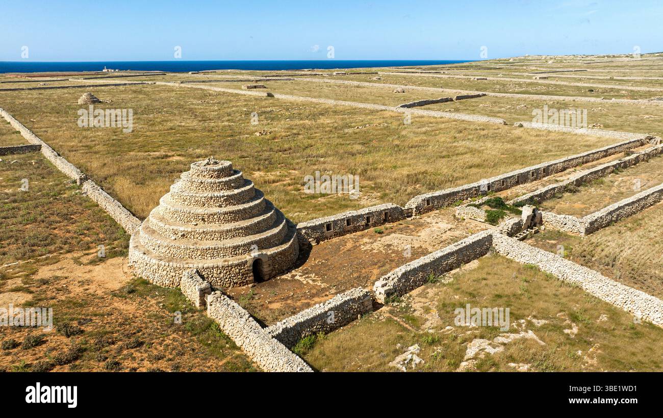 Étrange tour de pierre et murs de pierre le long du sentier de randonnée Camí de Cavalls à Punta Nati, Minorque, Espagne Banque D'Images