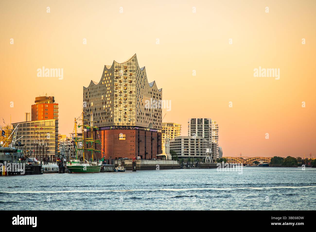 Hambourg, Allemagne - 11 mars 2025 : Elbphilharmonie, bateaux sur l'Elbe et Hamburg Skyline au coucher du soleil - éditorial illustratif maritime City Panorama Banque D'Images