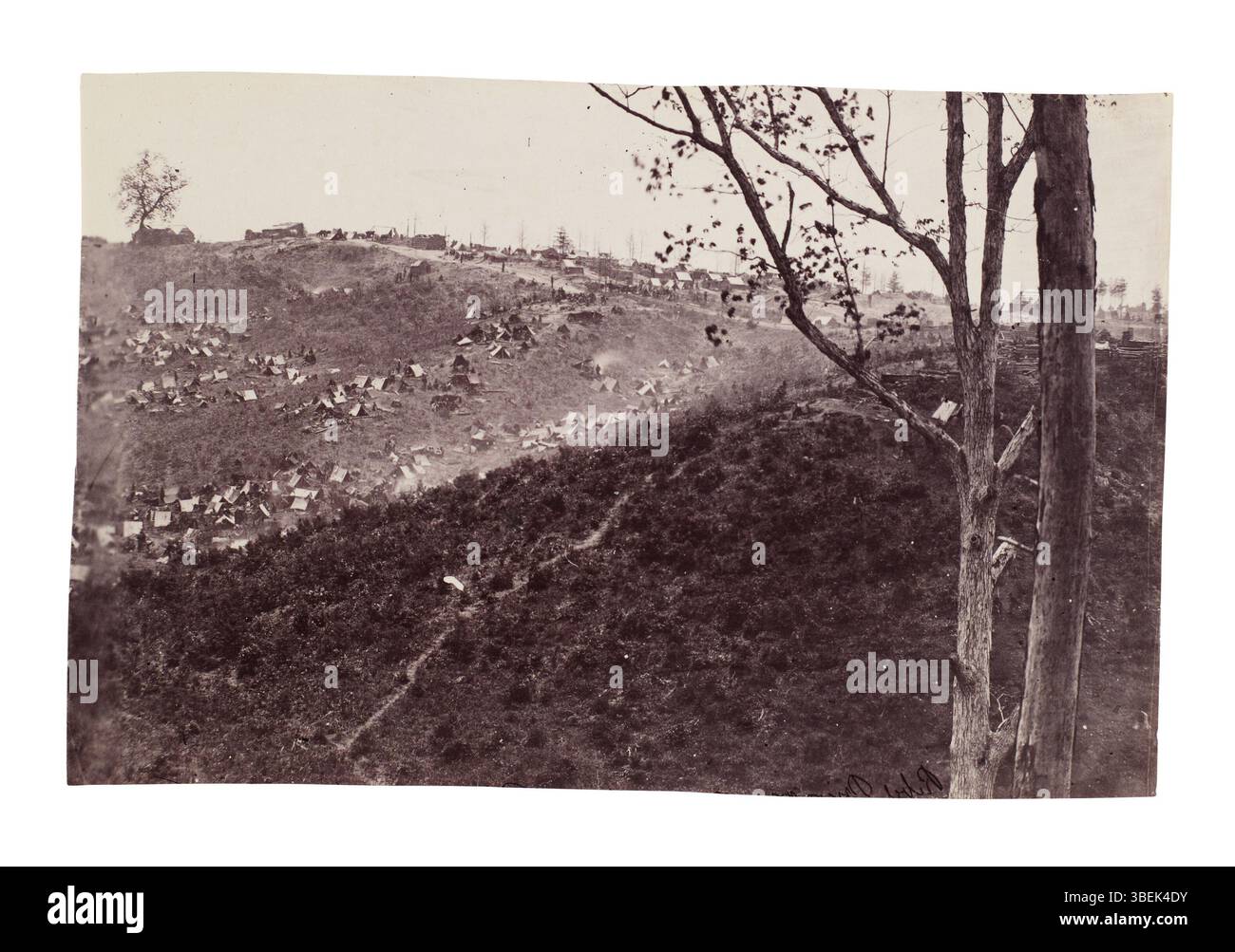 Cette photographie, attribuée à Timothy H. O'Sullivan, représente le camp de prisonniers confédérés à belle Plain Landing, en Virginie, après leur capture avec la division de Johnson le 12 mai 1864. L'image capture les conditions difficiles auxquelles les prisonniers ont été confrontés en captivité pendant la guerre civile. Banque D'Images